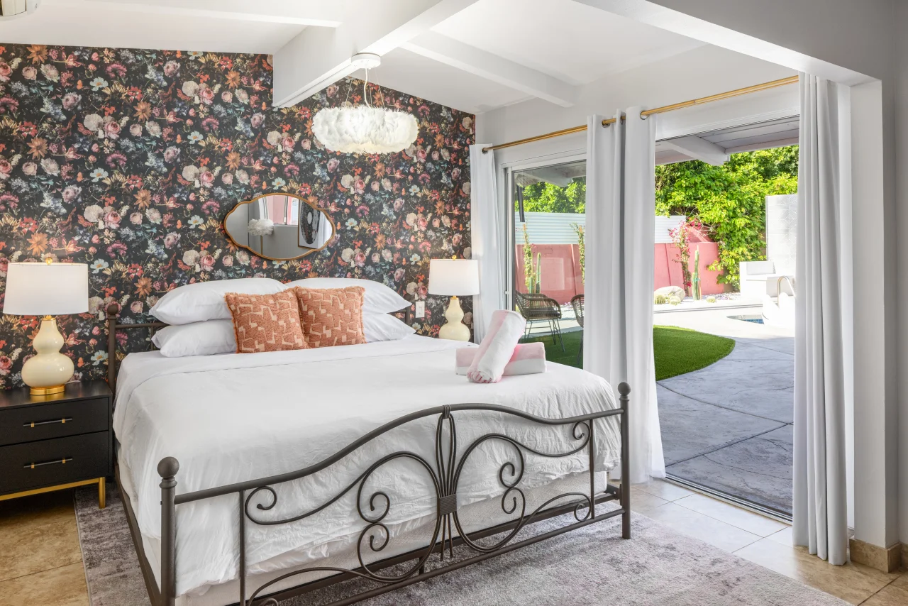 Luxurious bedroom suite with ornate canopy bed and floral wallpaper, showcasing personalized concierge service in Palm