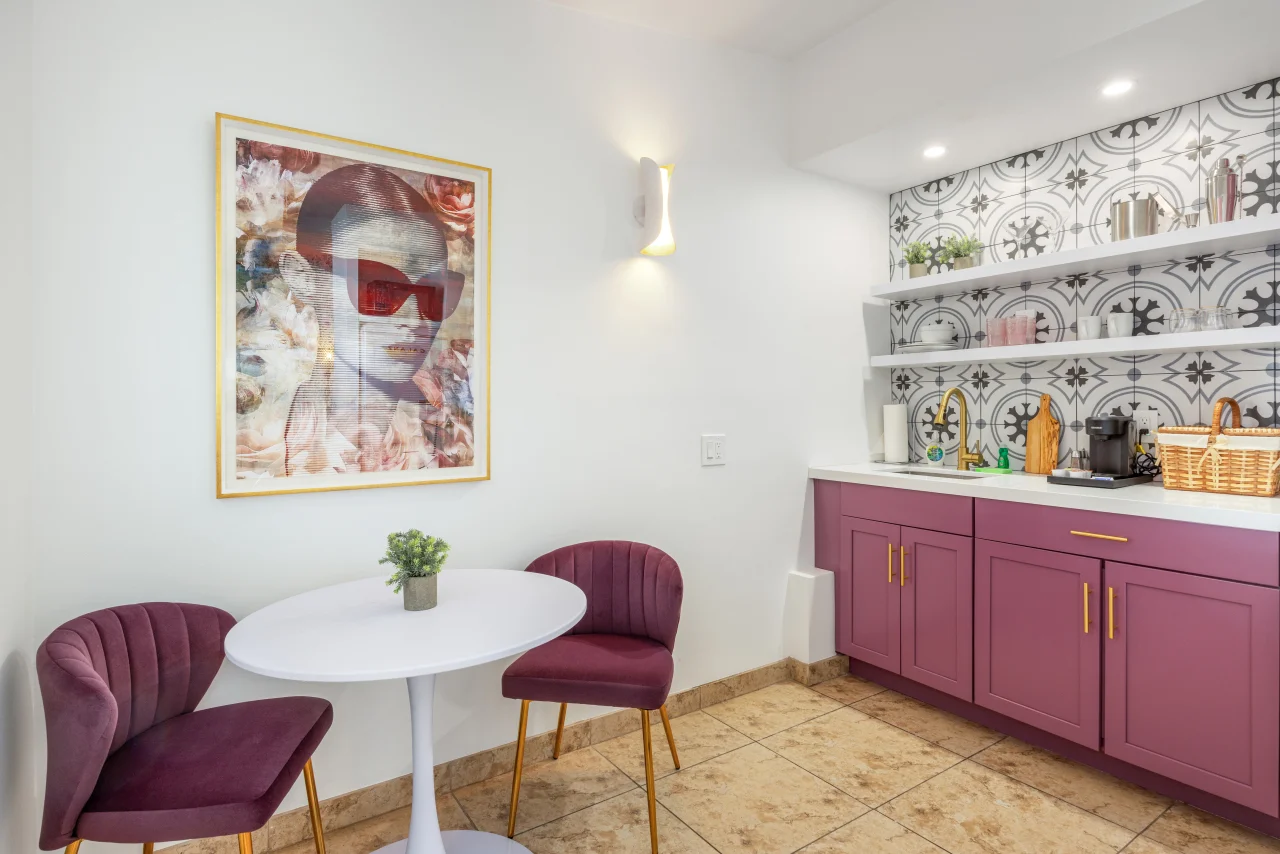 Modern kitchenette with burgundy velvet dining chairs and white round table, showing upscale dining space design in Palm