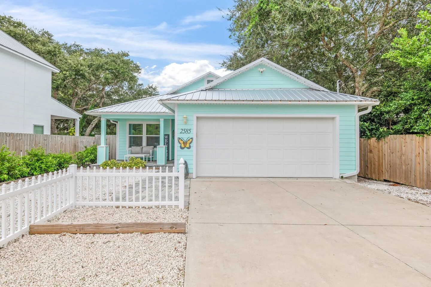 Mint-green cottage exterior with white trim for St Augustine vacation rental property management