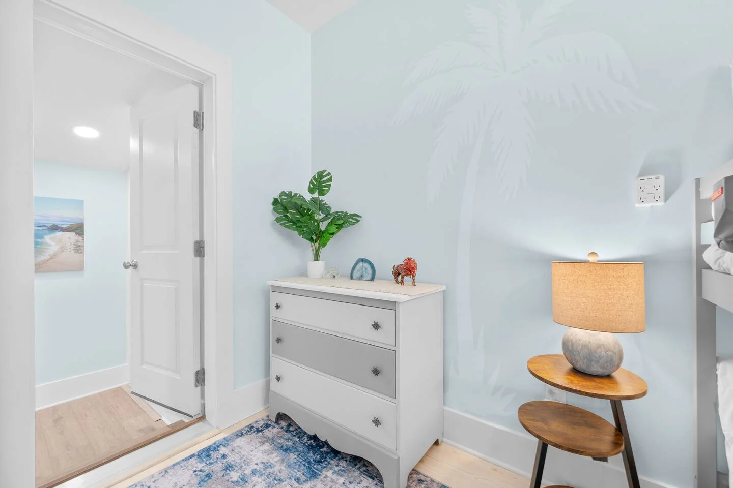 Modern coastal bedroom with light blue walls and beach decor optimized for Airbnb booking success in St. Augustine