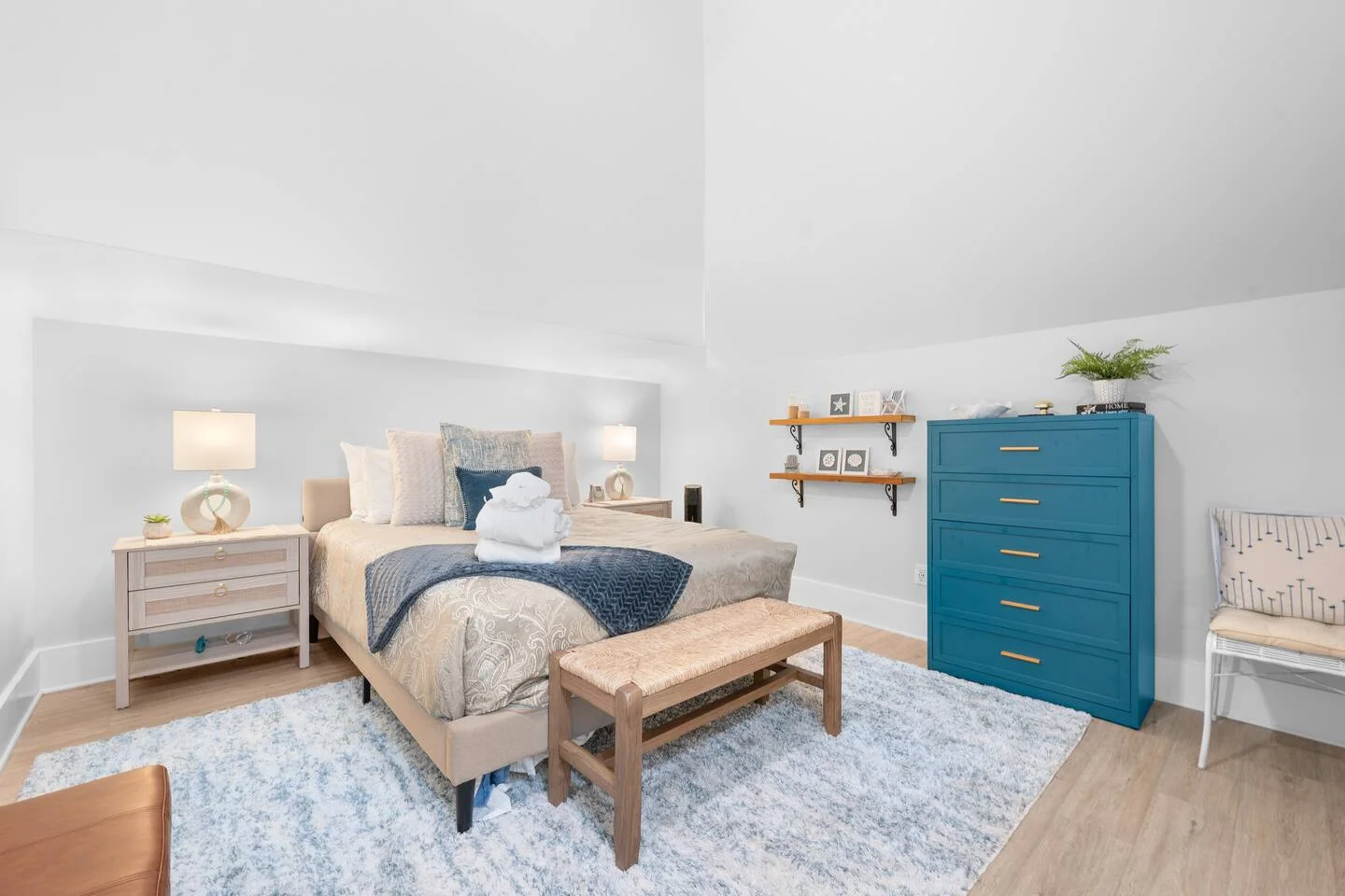 Professional bedroom photography showing coastal master bedroom with turquoise dresser and nautical decor in St. Augustine