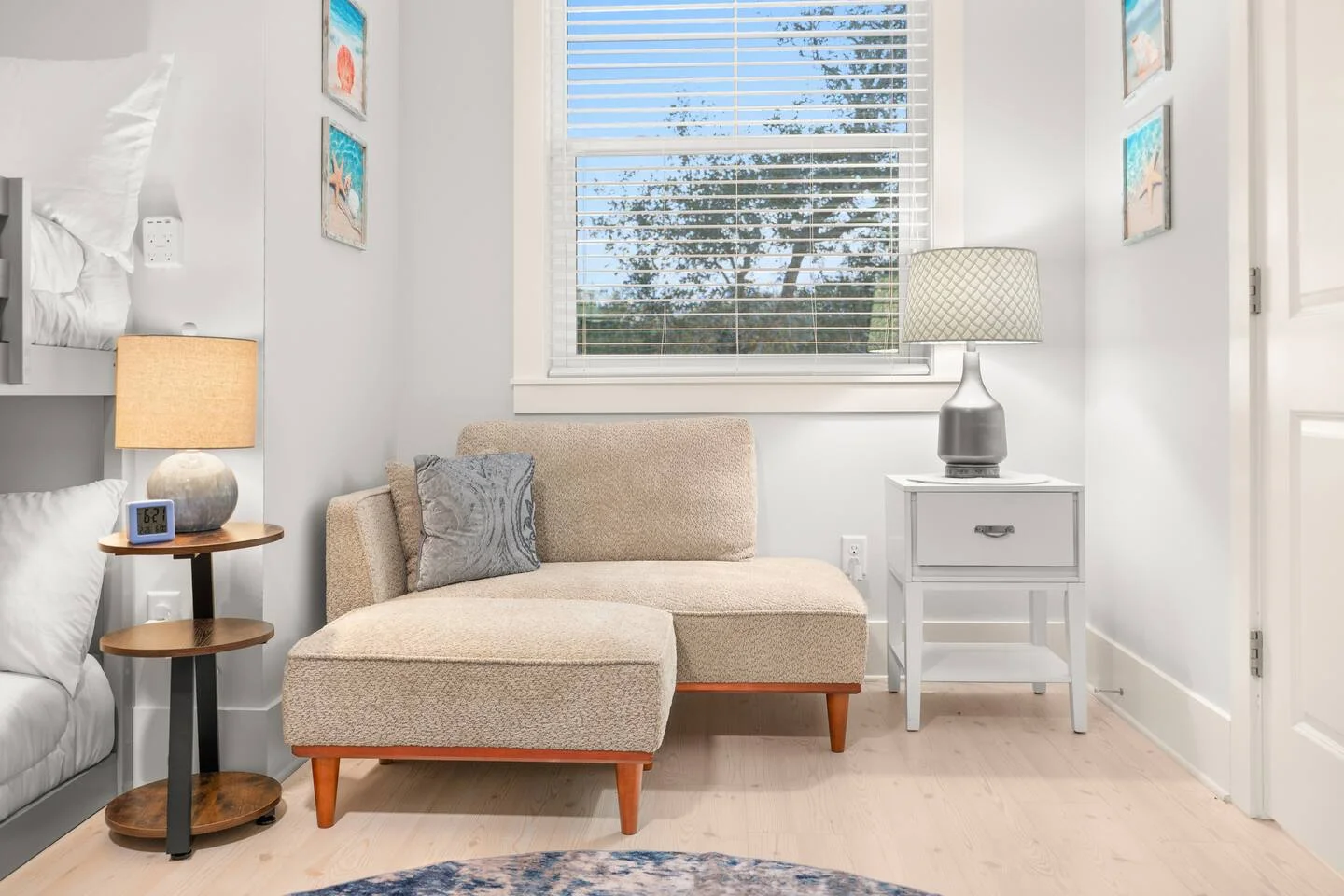 Modern coastal bedroom with chaise lounge and natural light in St. Augustine vacation rental
