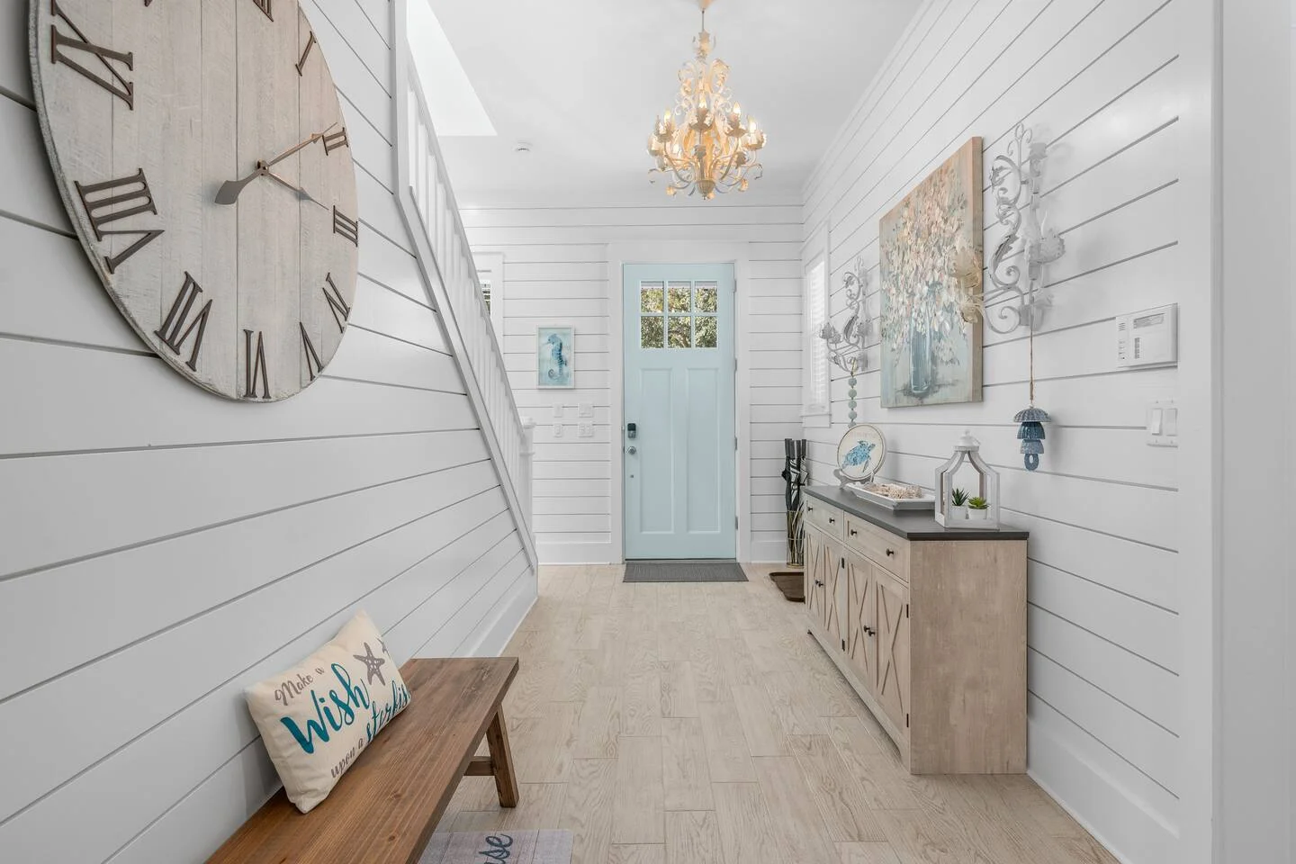Coastal entryway with white shiplap walls and light blue door in St. Augustine vacation rental