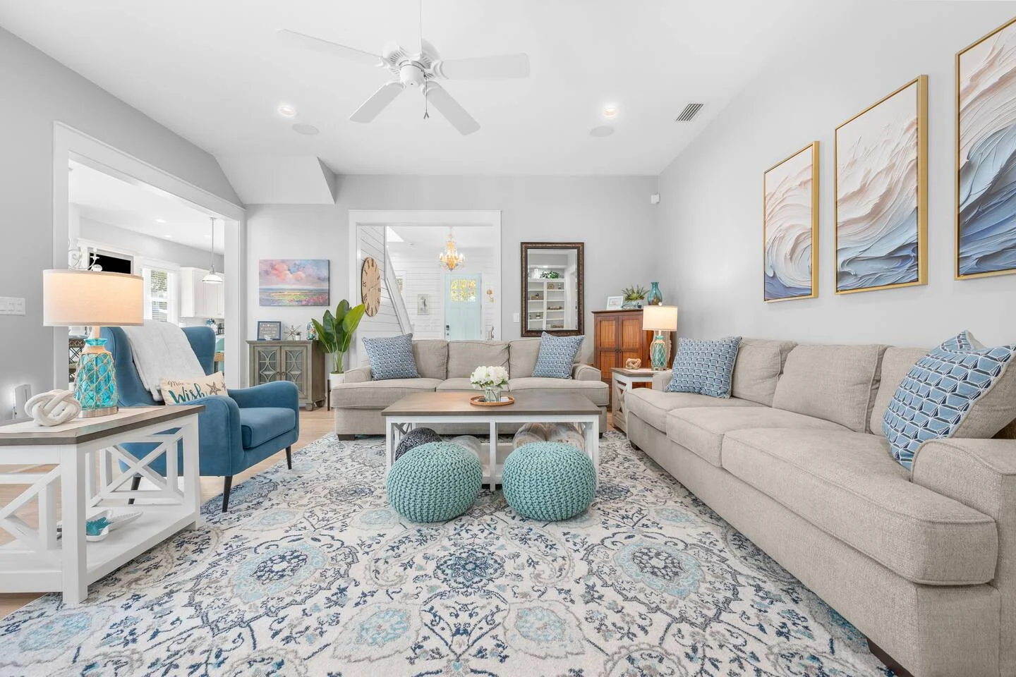 Coastal living room with beige sectional and blue accents to increase Airbnb bookings in St. Augustine