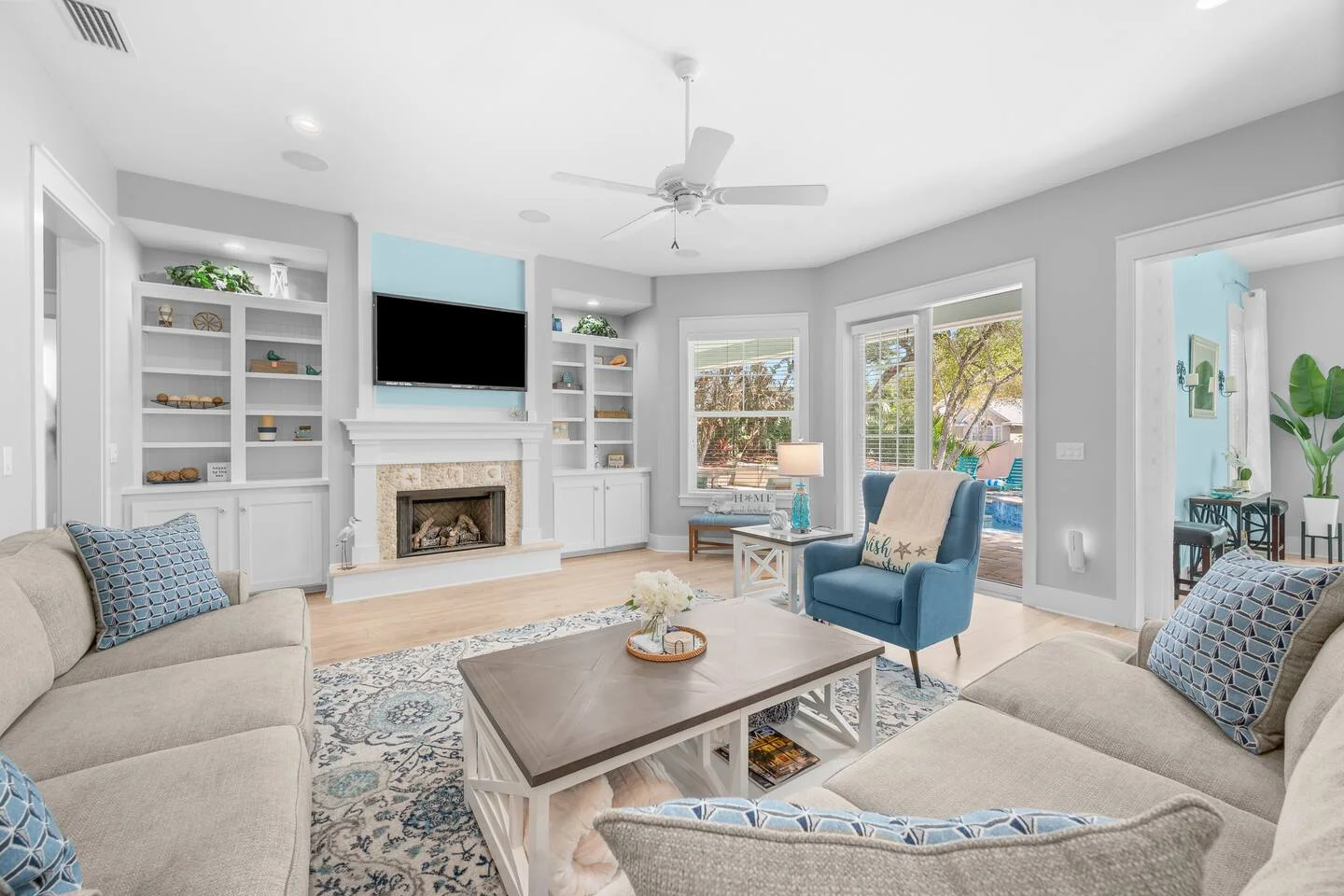 Bright coastal living room with ocean views and built-in fireplace in St. Augustine vacation rental