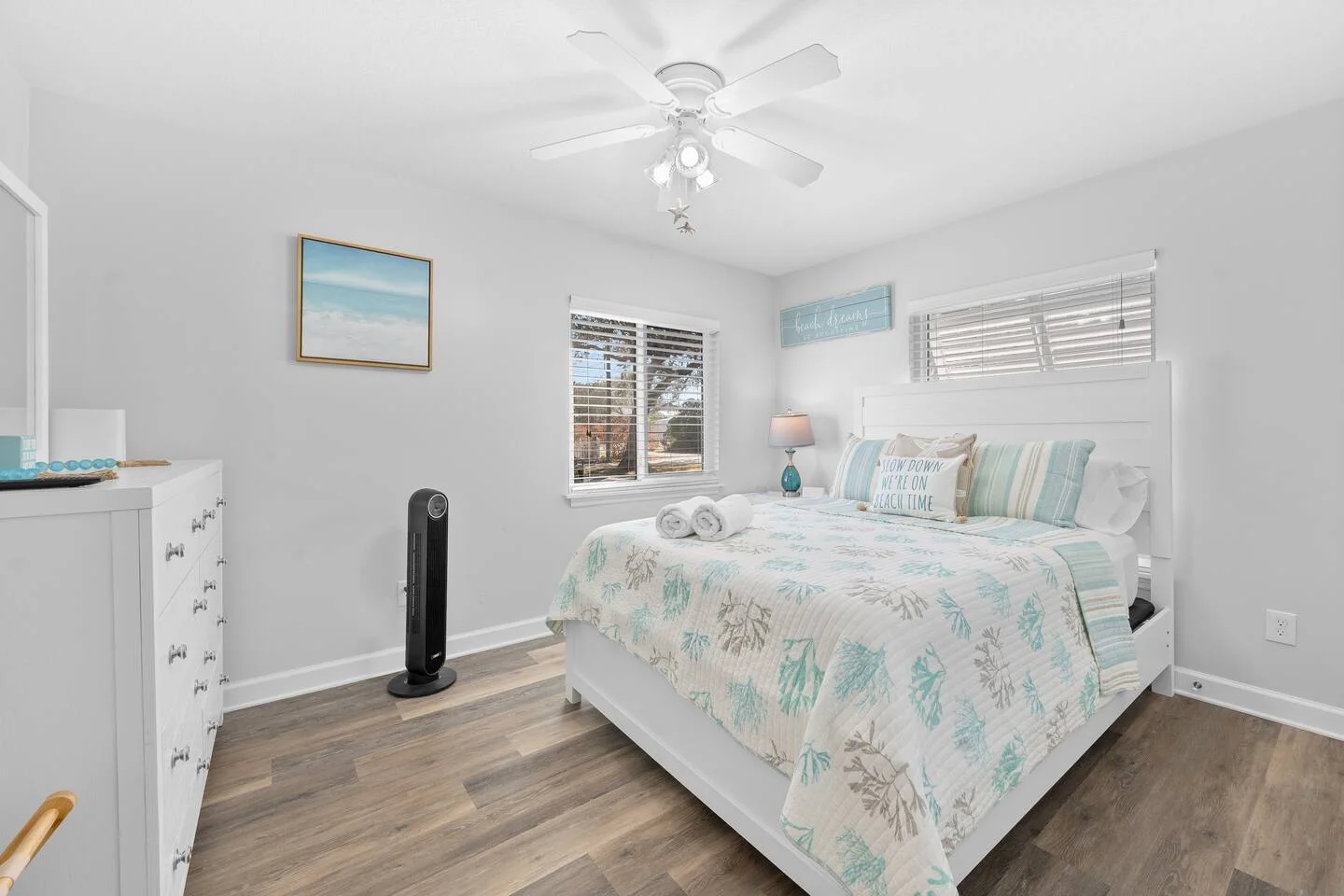 Coastal bedroom with white shiplap, turquoise bedding, and beach decor in St. Augustine vacation rental