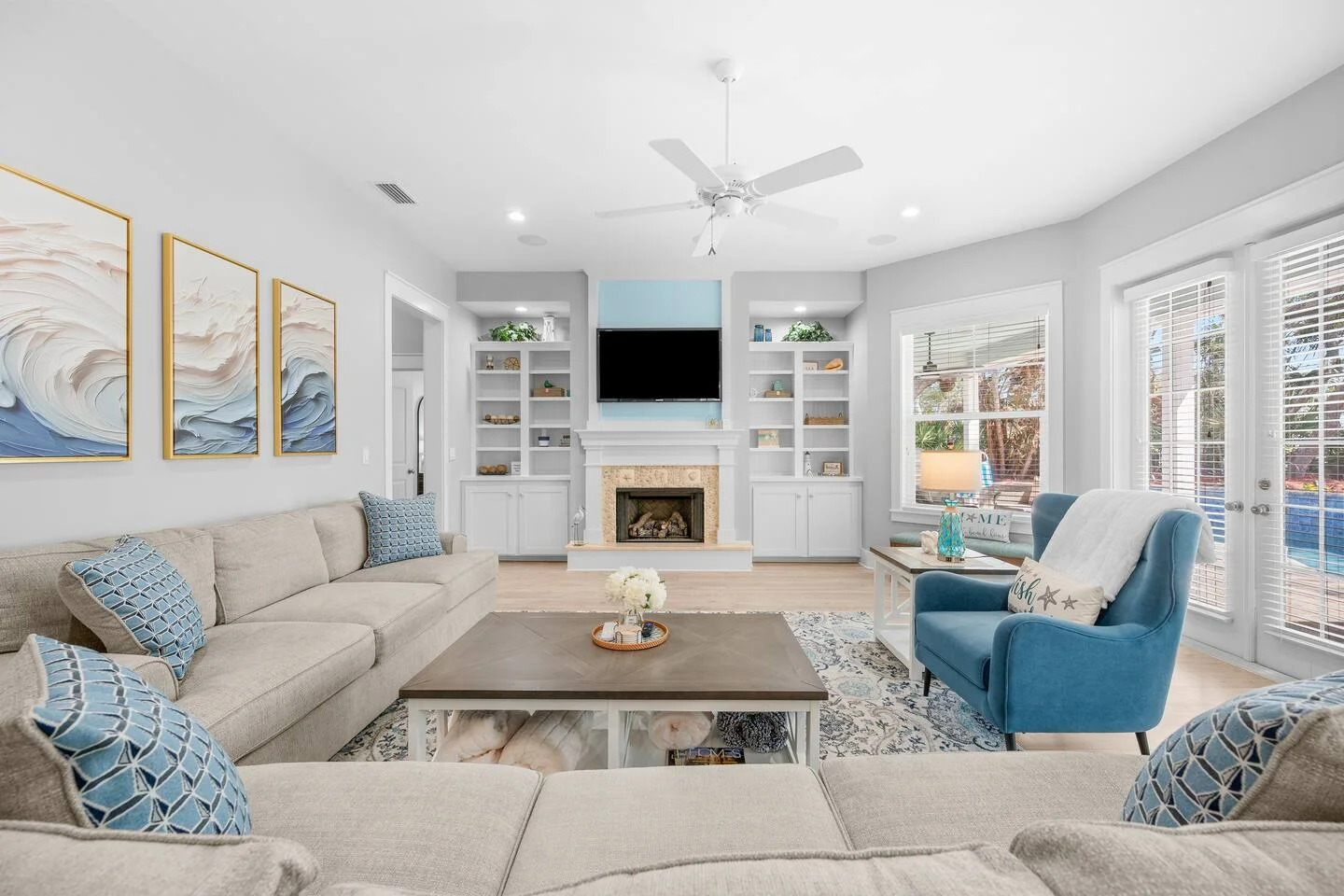 Modern coastal living room with fireplace and built-in shelving in St. Augustine vacation rental