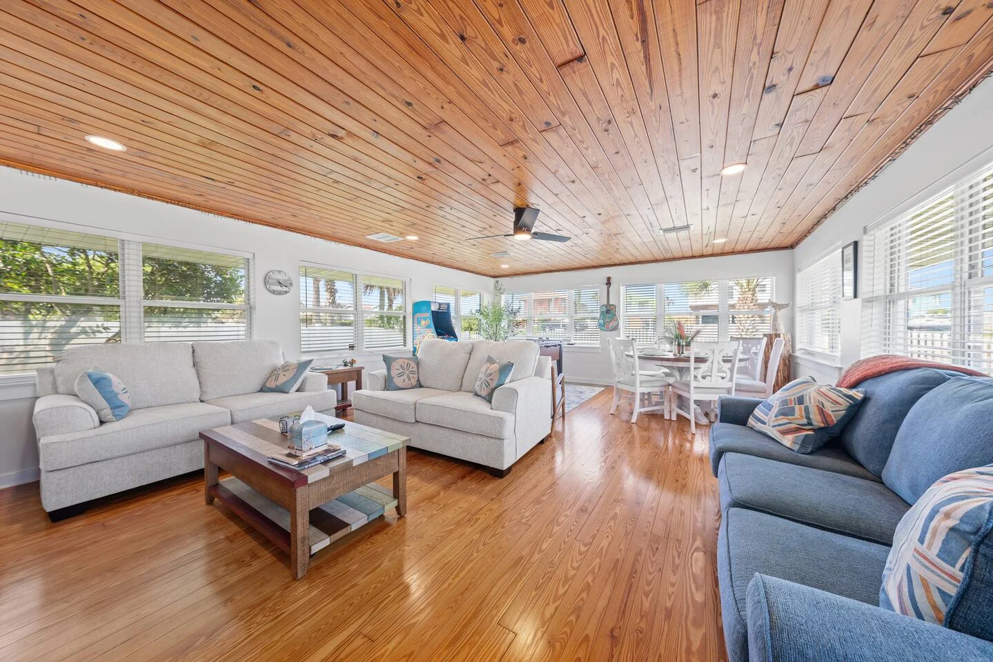 Bright coastal living room with wooden ceilings and ocean views in a St. Augustine vacation rental
