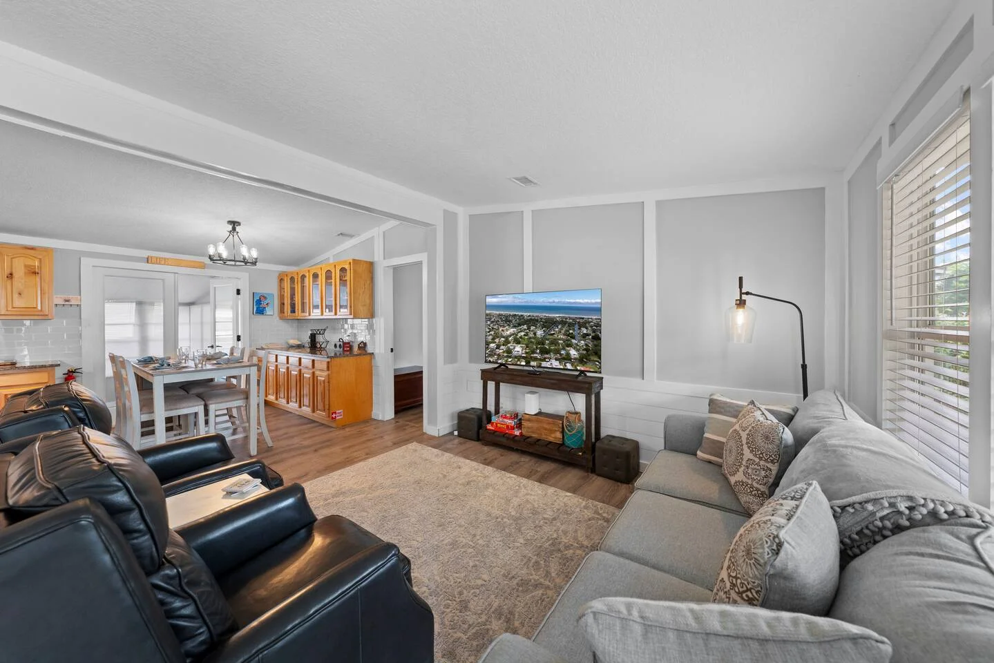 Open-concept living room with comfortable seating and modern amenities for evaluating property management value in St.