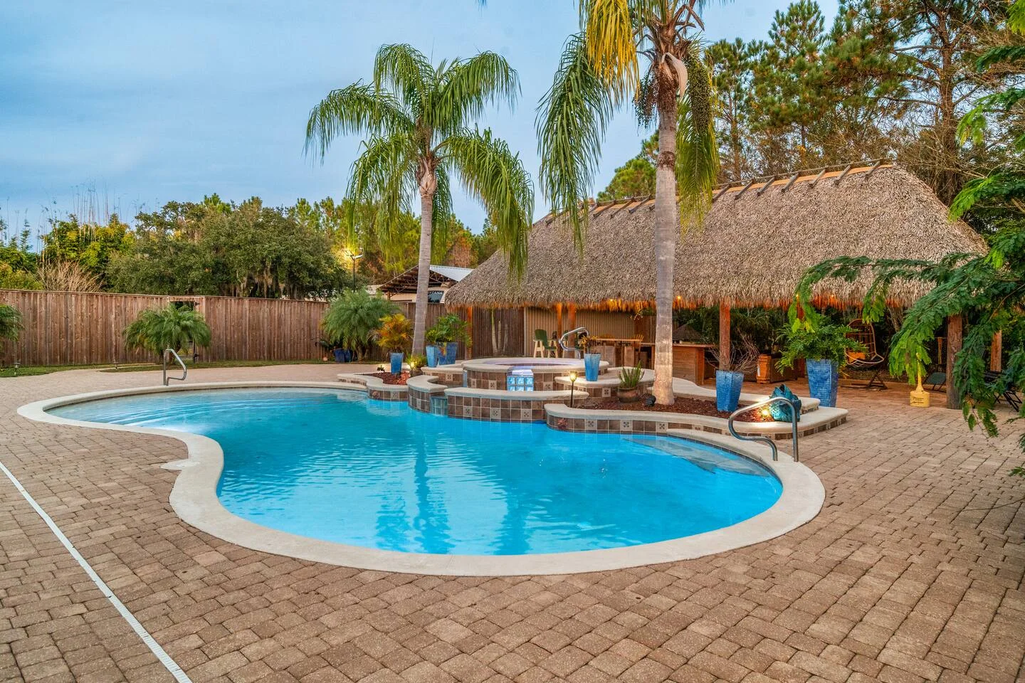 Luxury resort-style backyard pool with spa and tropical landscaping for St. Augustine property management