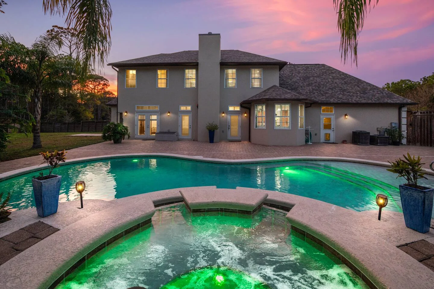 Luxury St Augustine vacation rental with resort-style pool and spa at twilight, ideal for short-term rental property