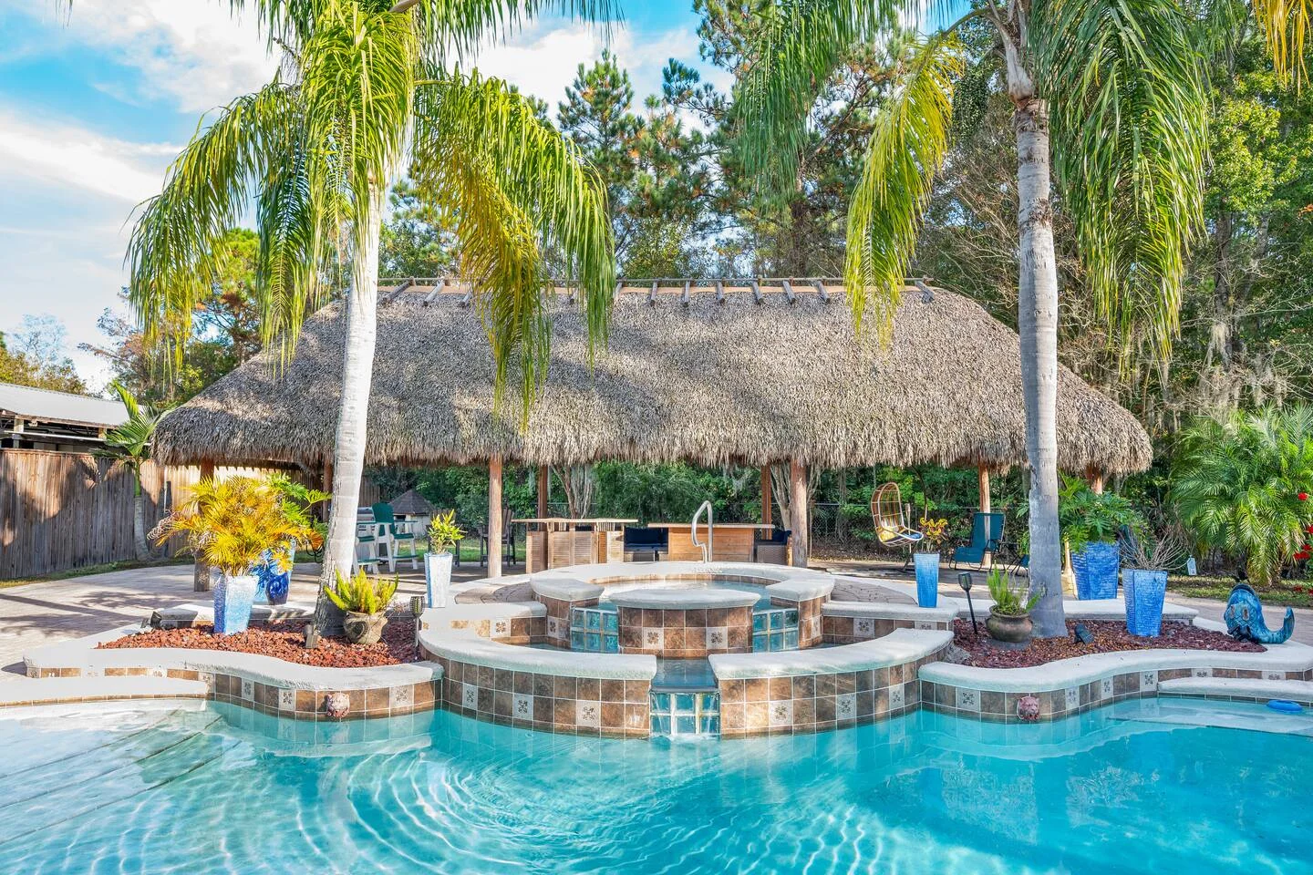 Luxurious tropical pool area with turquoise water and spa maintained by professional cleaning services for St Augustine