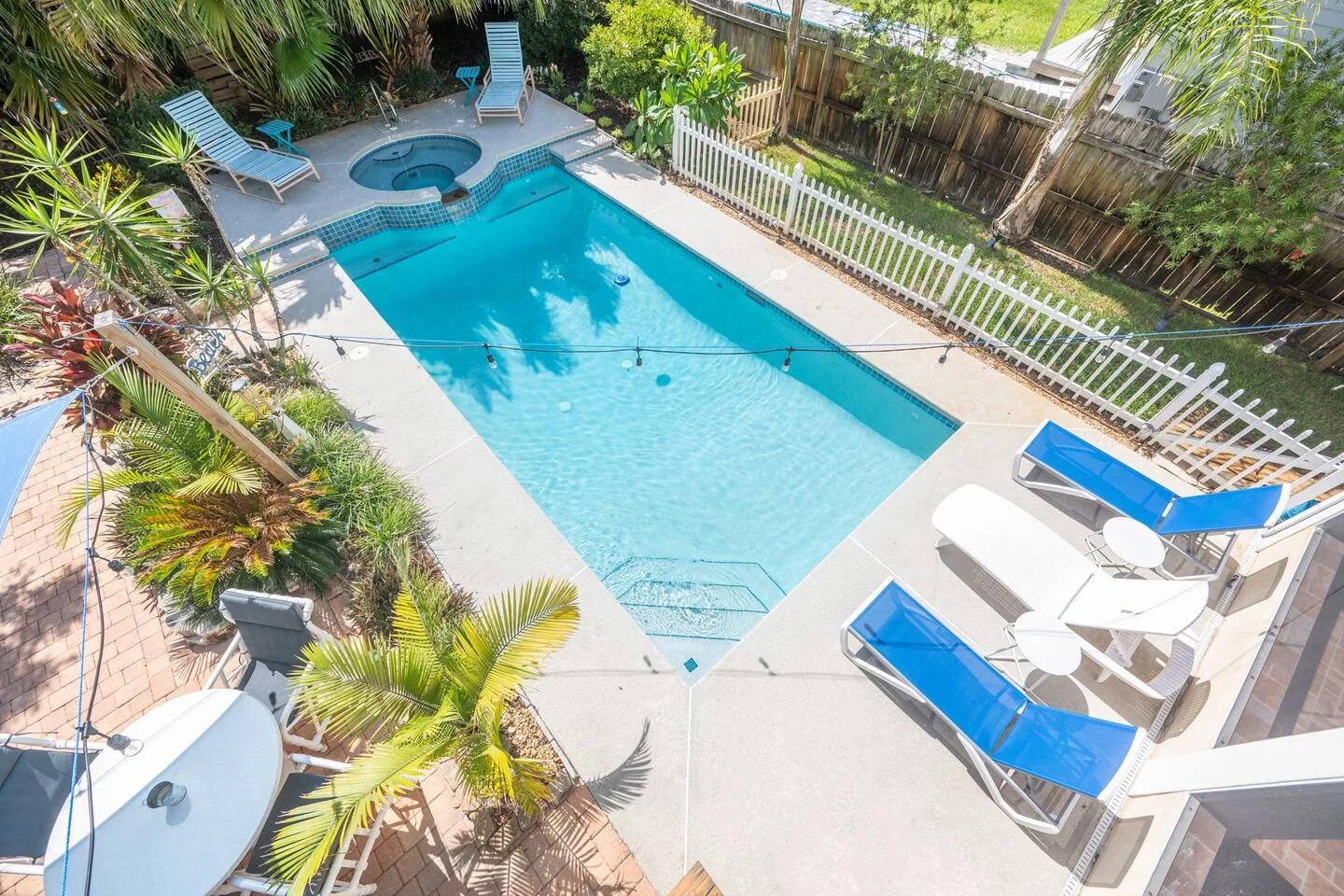 St. Augustine vacation rental pool with hot tub and tropical landscaping, key amenity for property managers.