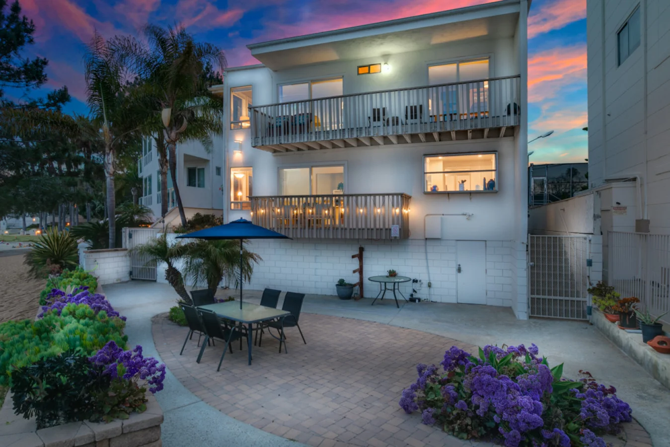 Modern beachfront investment property in San Diego managed by West Coast Homestays with patio and coastal sunset view