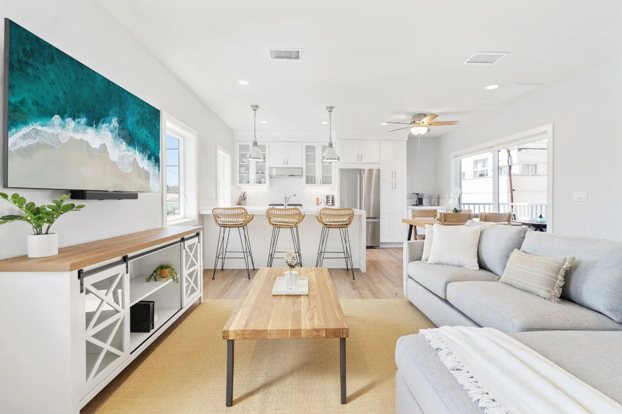 Modern coastal open-concept living room for a La Jolla Shores vacation rental with kitchen island and ocean views