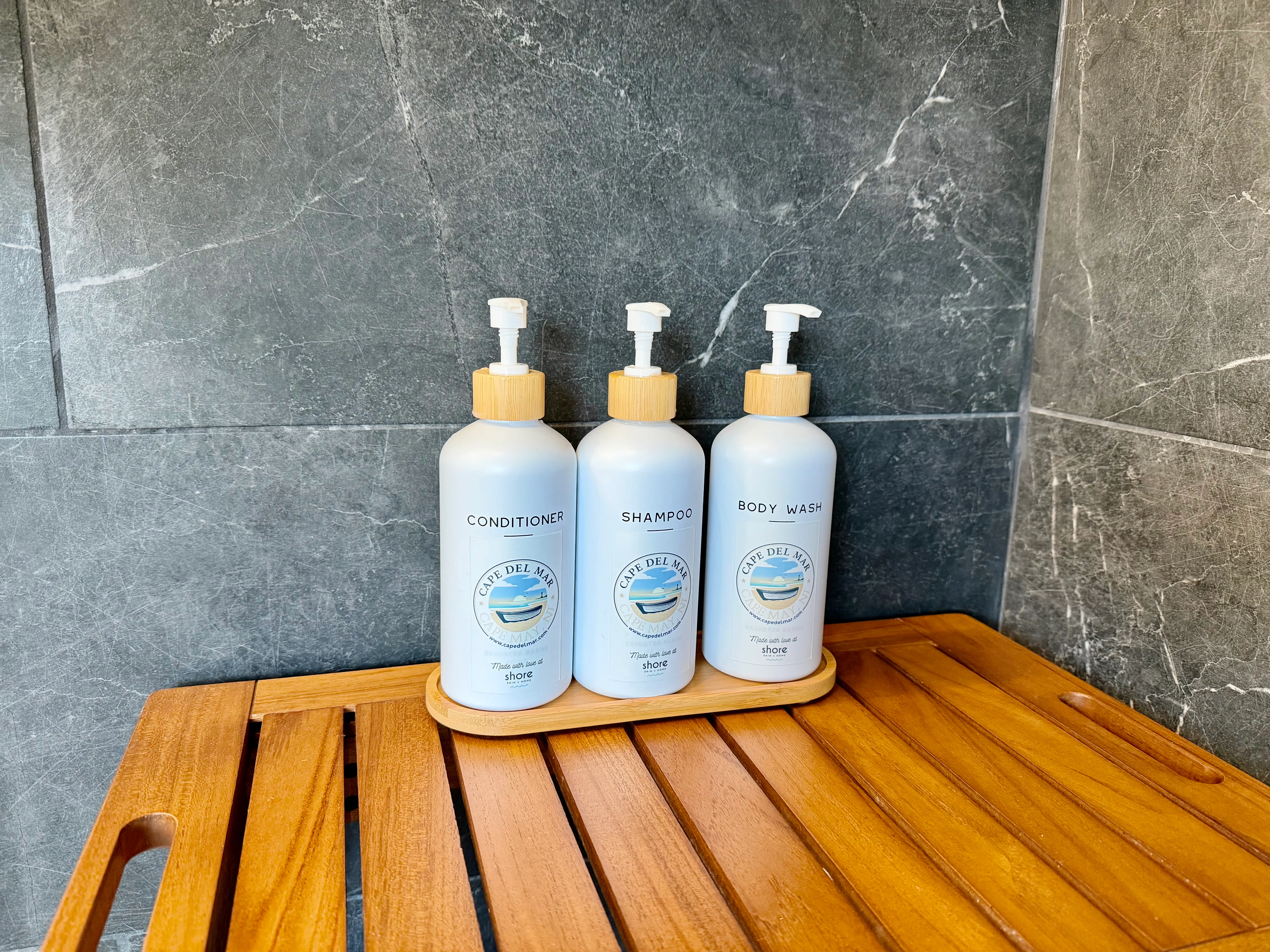 Luxury bathroom amenities with shampoo, conditioner, and body wash bottles at Cape May pet-friendly hotel