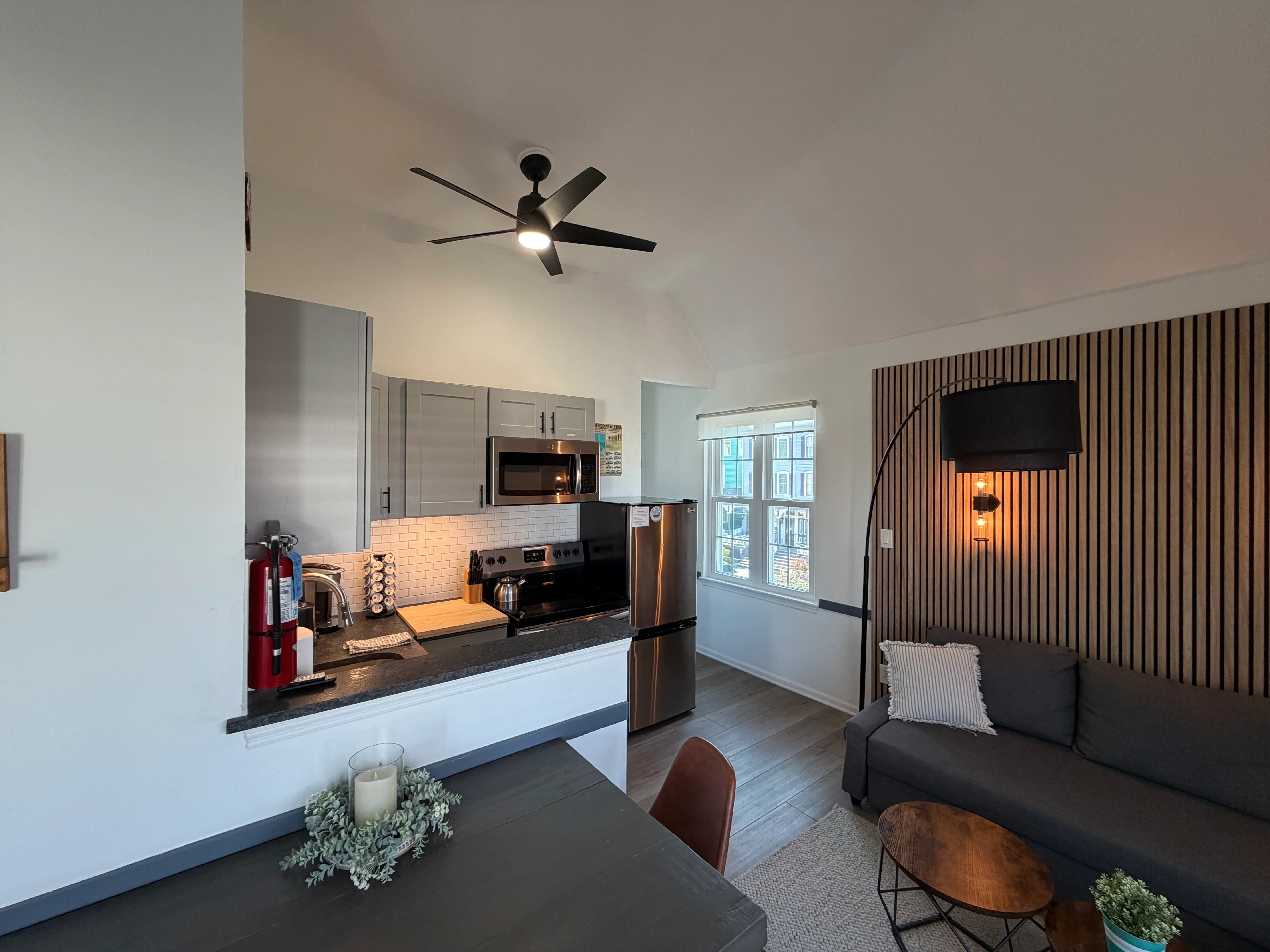 Modern open-concept kitchen with stainless steel appliances and white subway tile at Cape Surf Cape May NJ