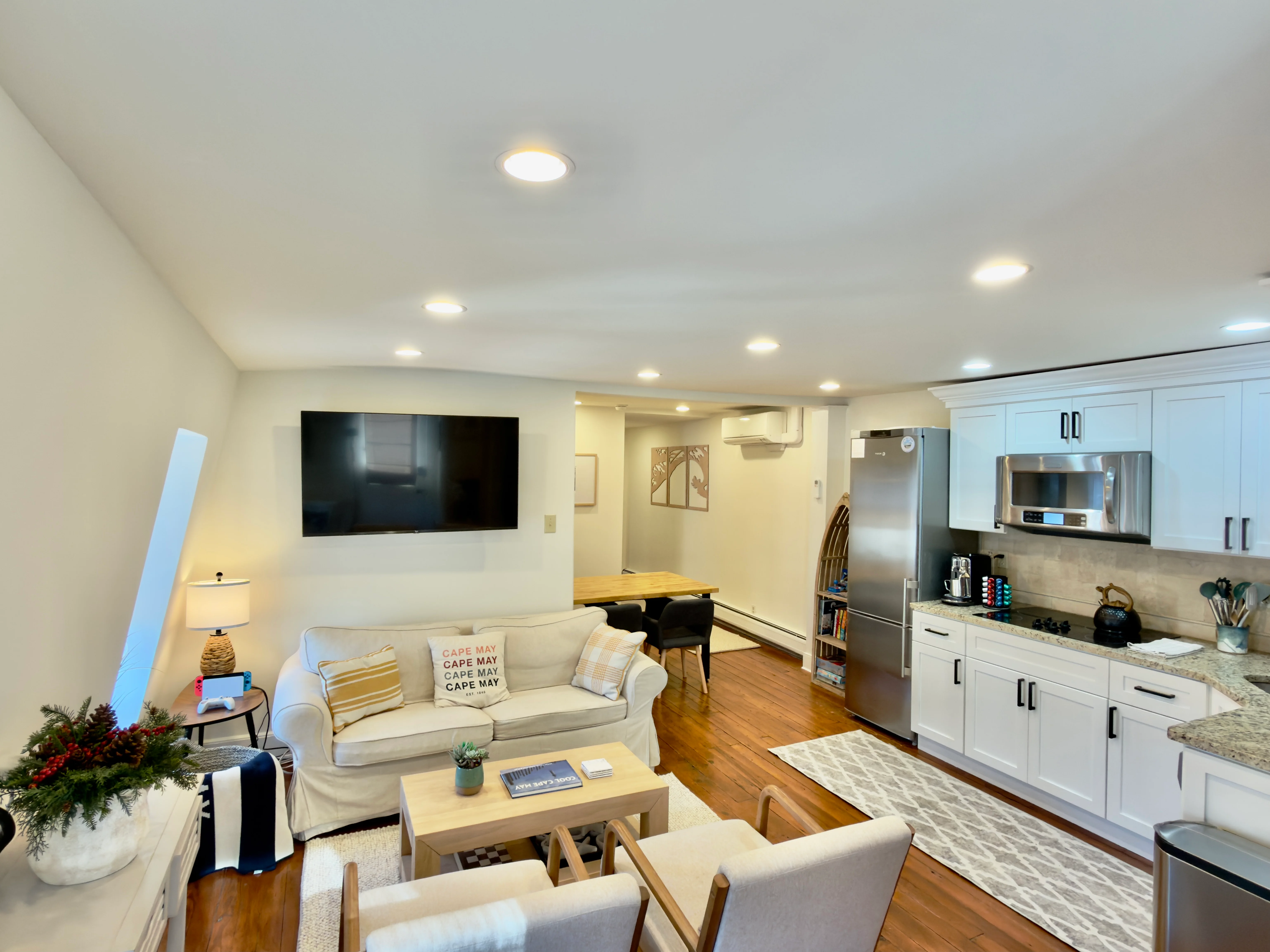 Modern basement living room with integrated kitchen and seating area in a Cape May New Jersey vacation rental property