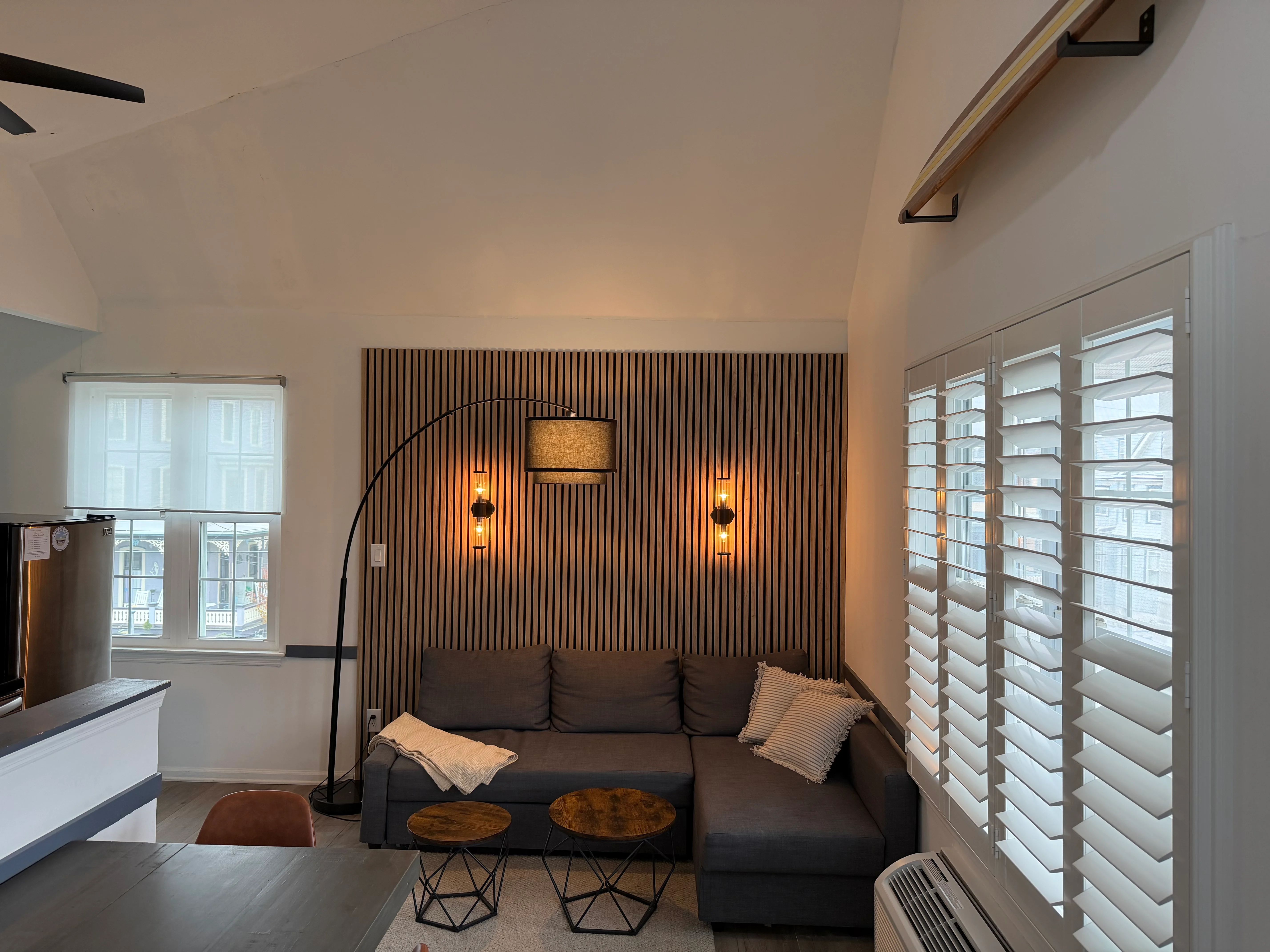 Modern living room with sectional sofa and ocean views at Cape Surf vacation rental in Cape May