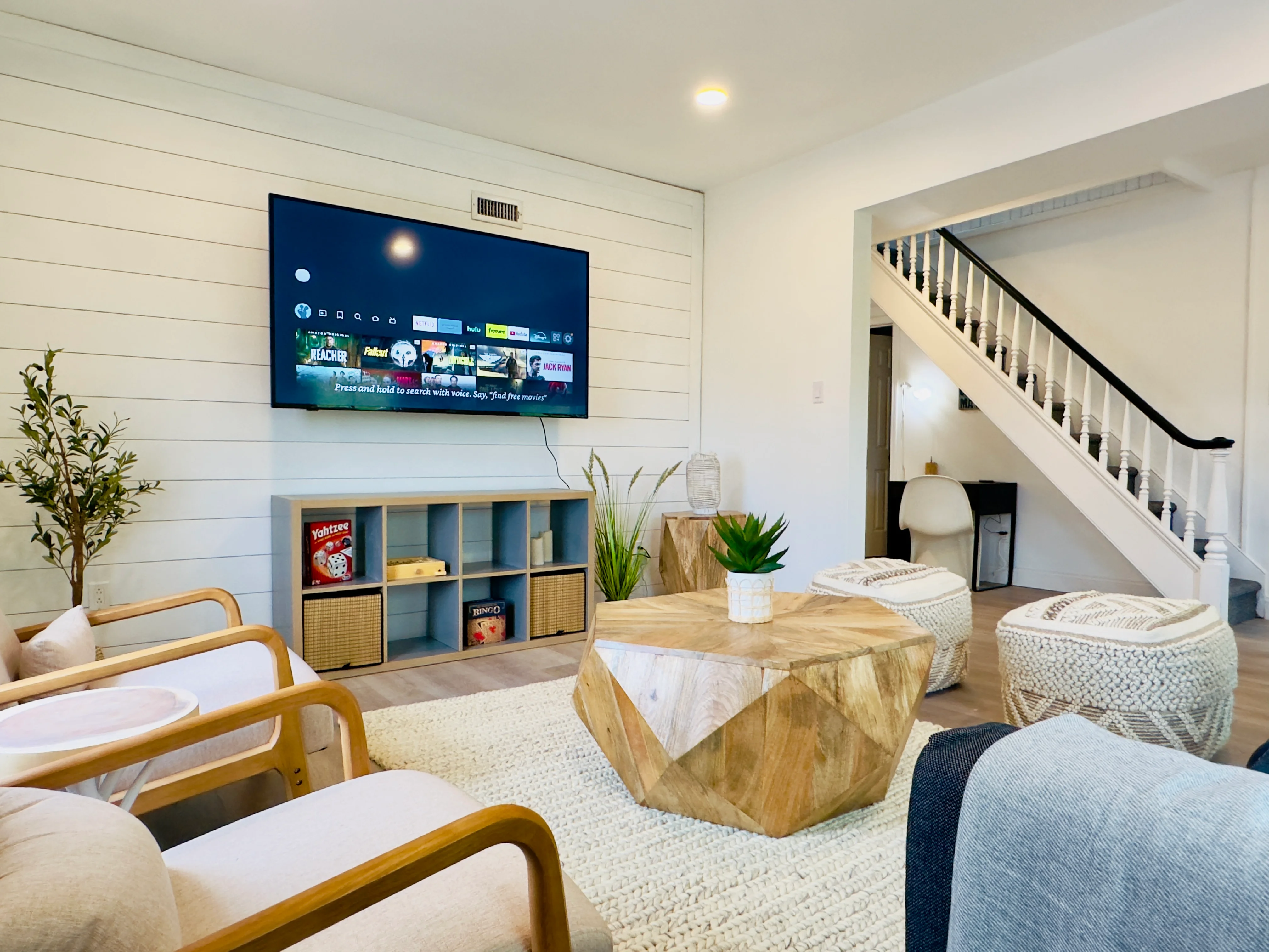 Modern open-concept living room with shiplap walls and natural wood accents at Cape Belvedere in Cape May