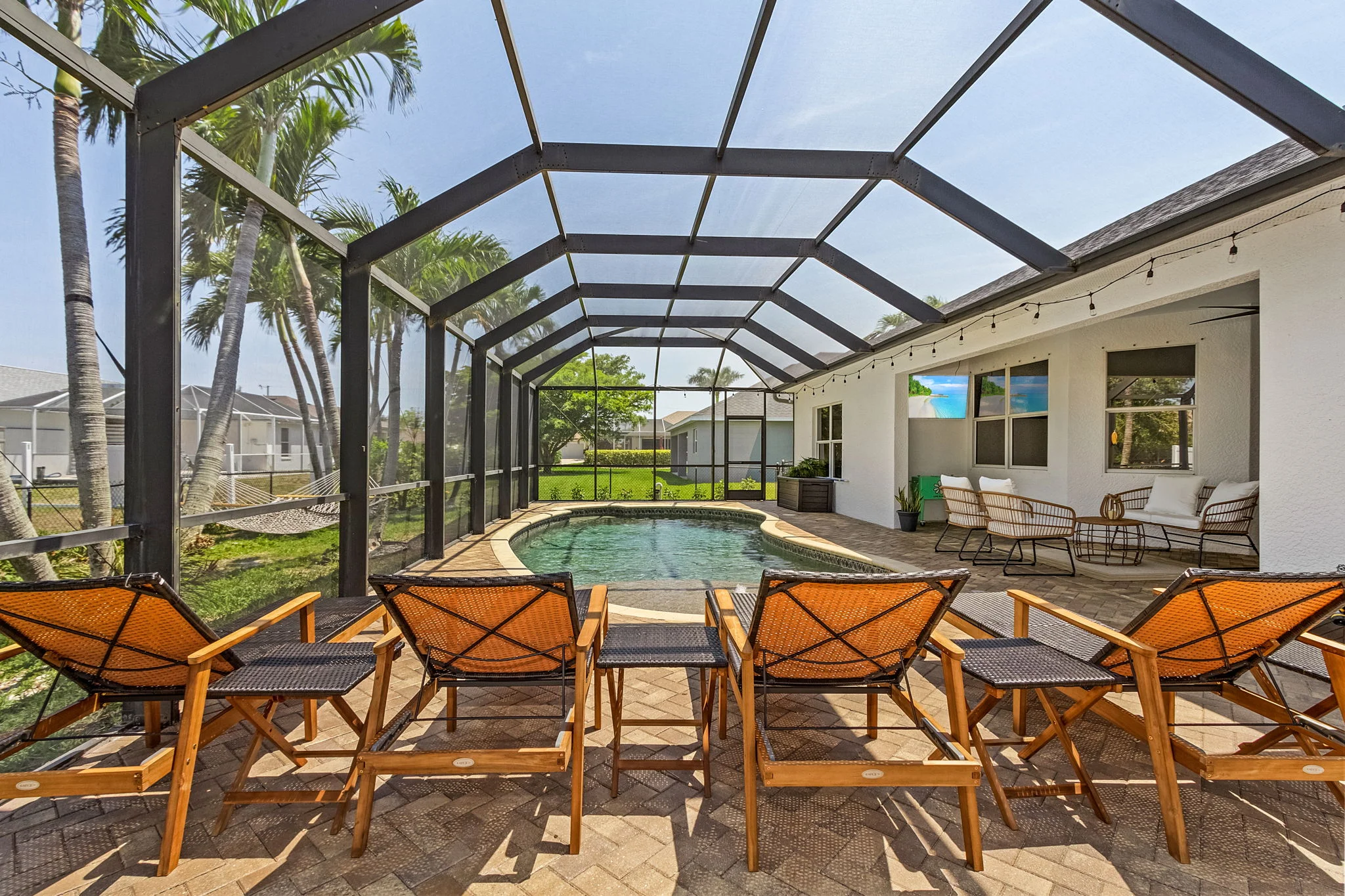 Cape Pelican screened saltwater pool with lanai and lounge chairs, vacation rental near best food Cape Coral