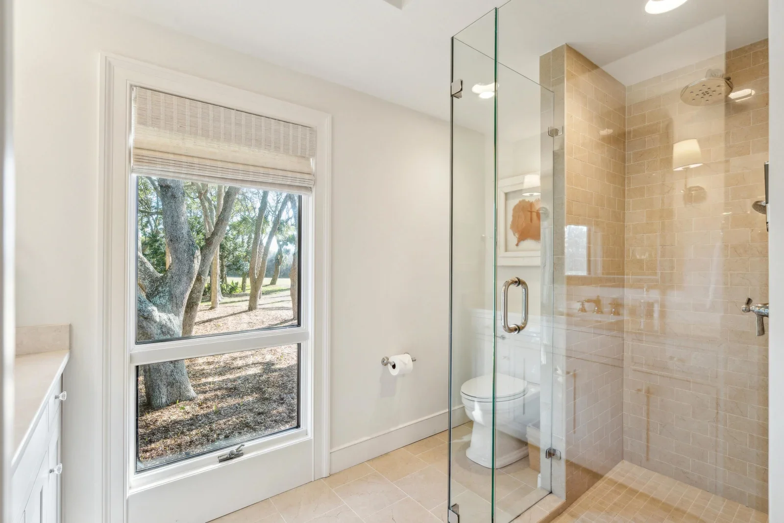 Modern bathroom with frameless glass shower and natural light in Kiawah Island South Carolina vacation rental