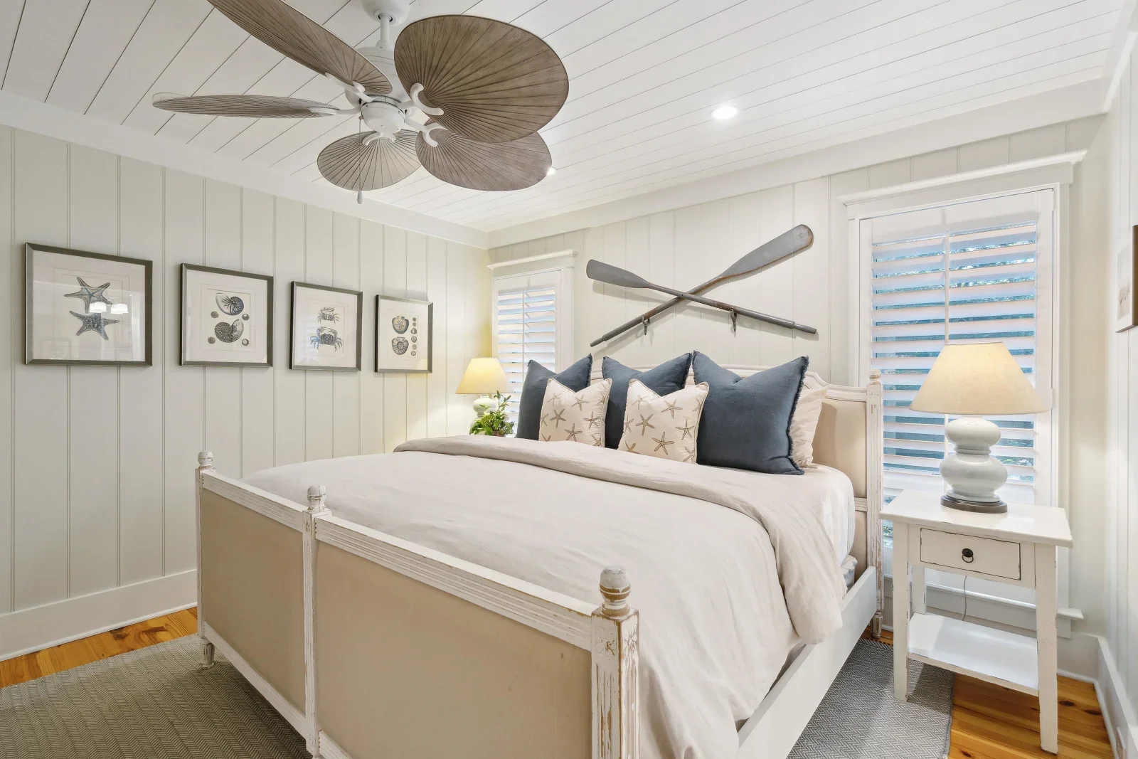 Coastal bedroom with whitewashed bed, nautical decor, and ocean views at Kiawah Island vacation rental