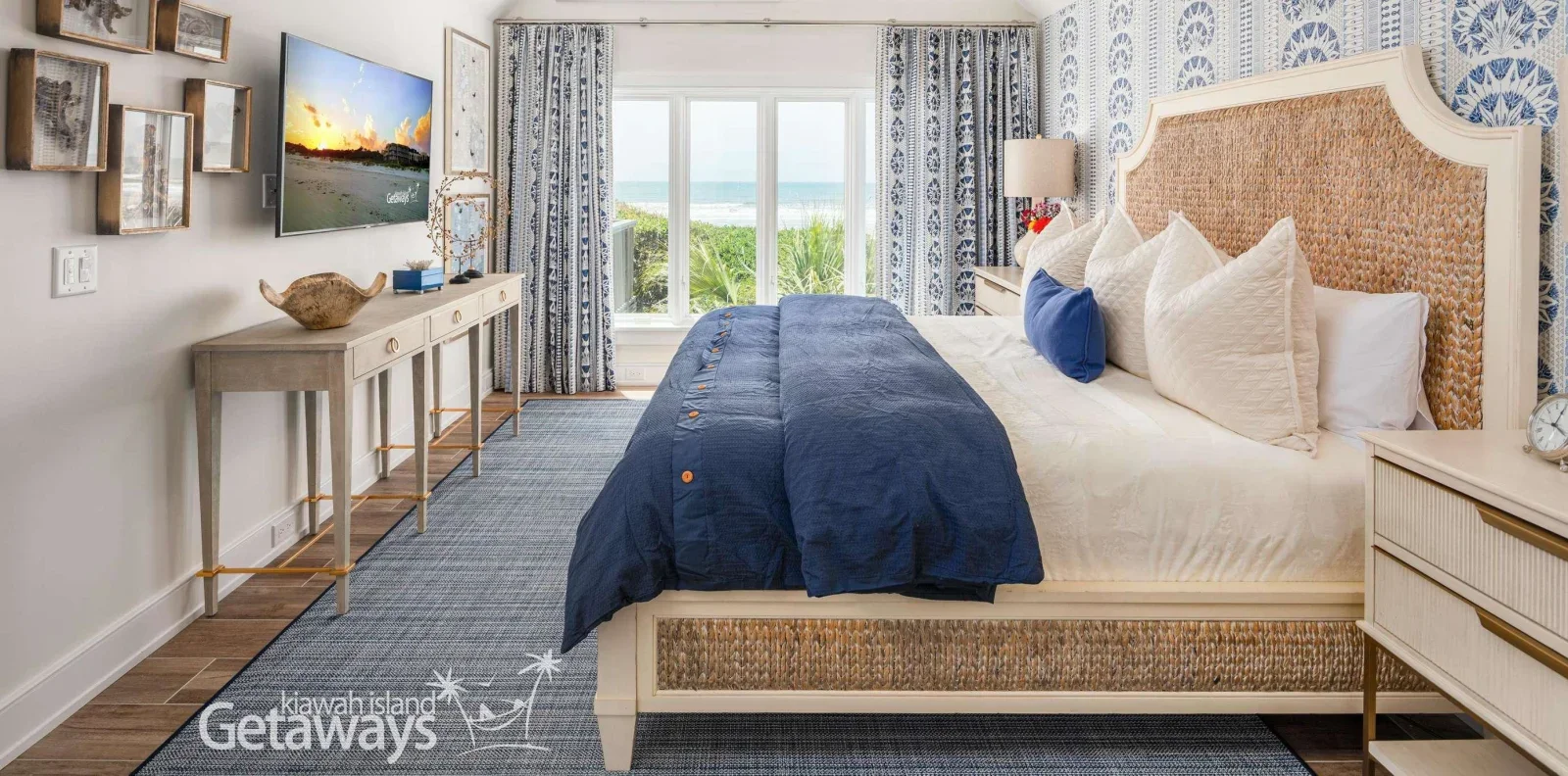 Kiawah Island beachfront bedroom with ocean views through glass doors and coastal furnishings in blues and neutrals