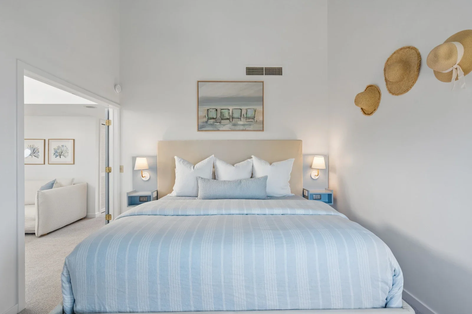 Coastal master bedroom with beige headboard and blue striped bedding at Kiawah Island vacation rental