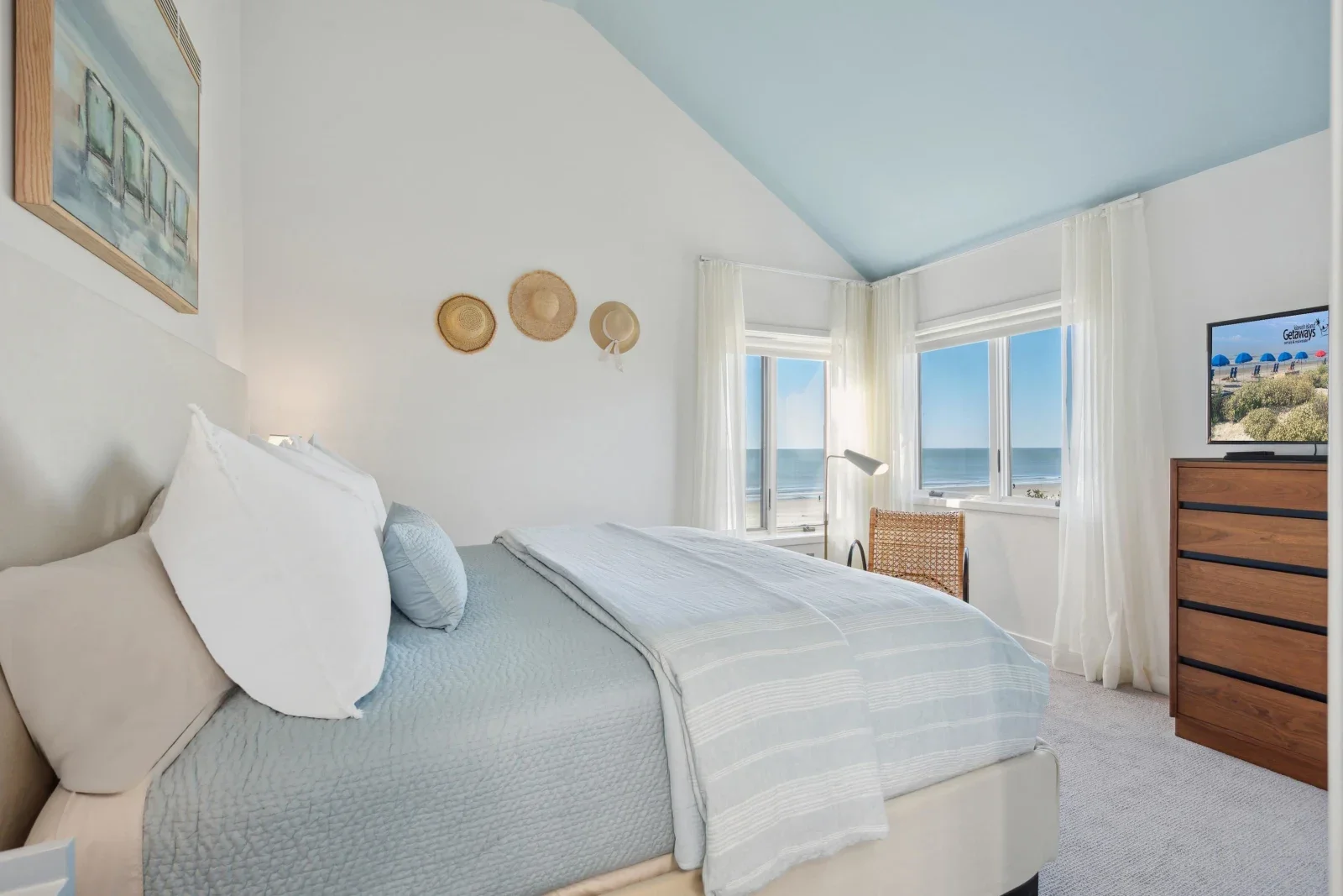 Master bedroom with ocean view and beach-themed decor at Kiawah Island rental property