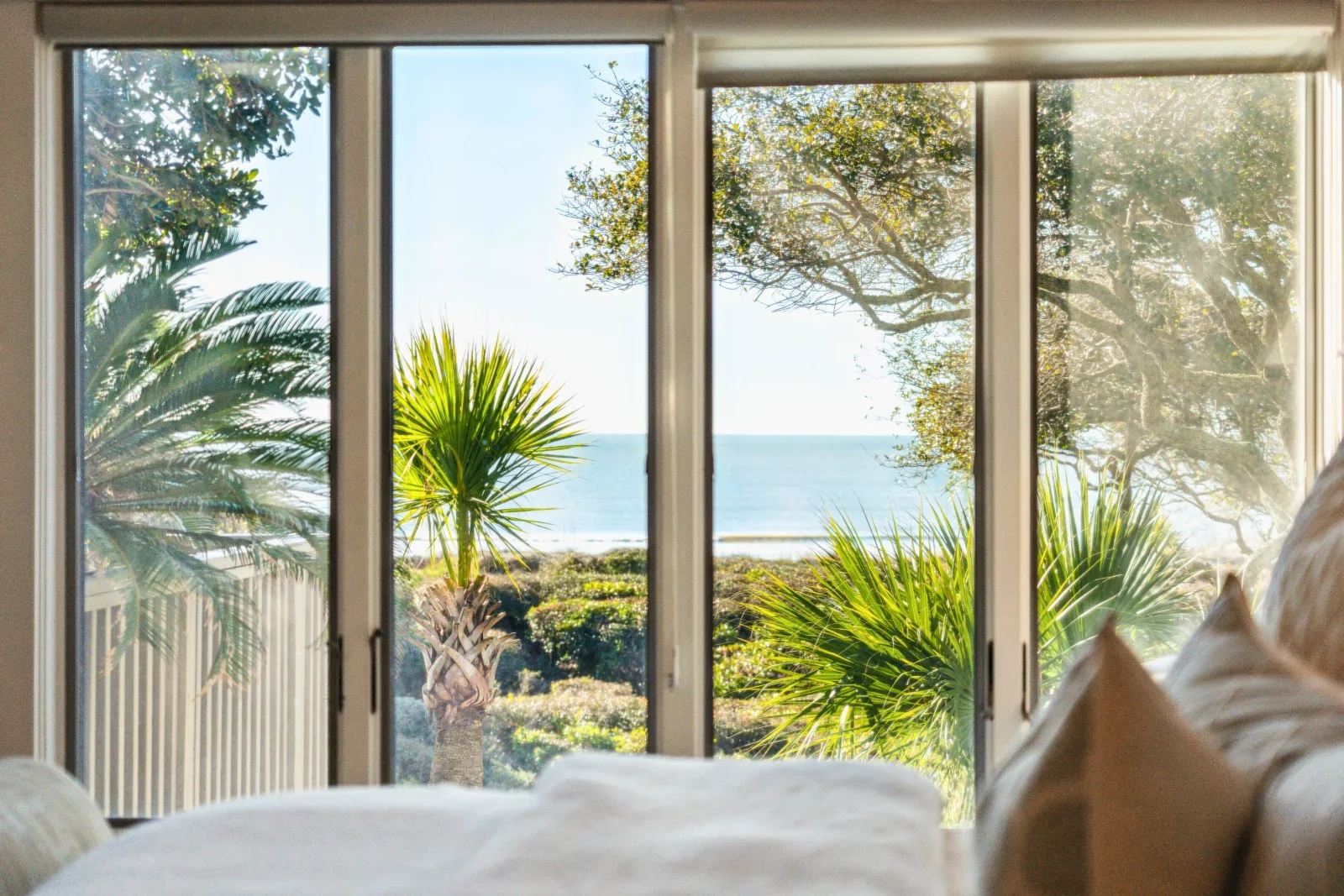 Oceanfront bedroom with glass doors overlooking Kiawah Island SC beach, things to do include waking up to ocean views