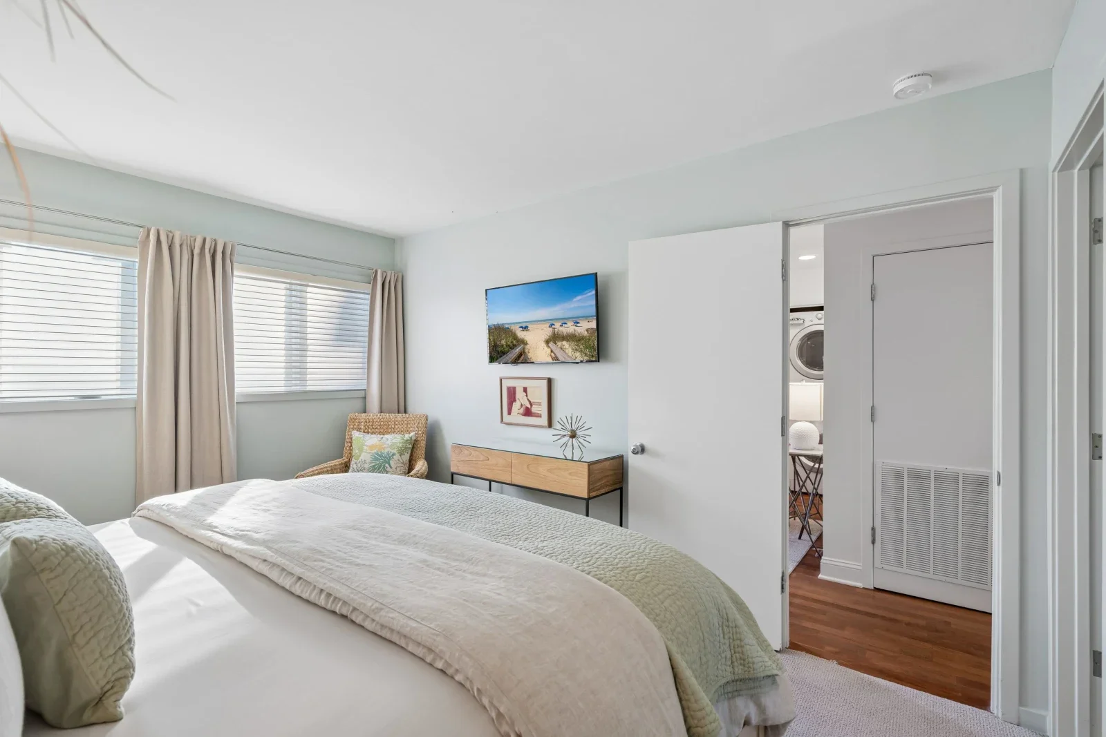 Primary bedroom with blue-green walls and ocean views in oceanfront Kiawah Island rental villa