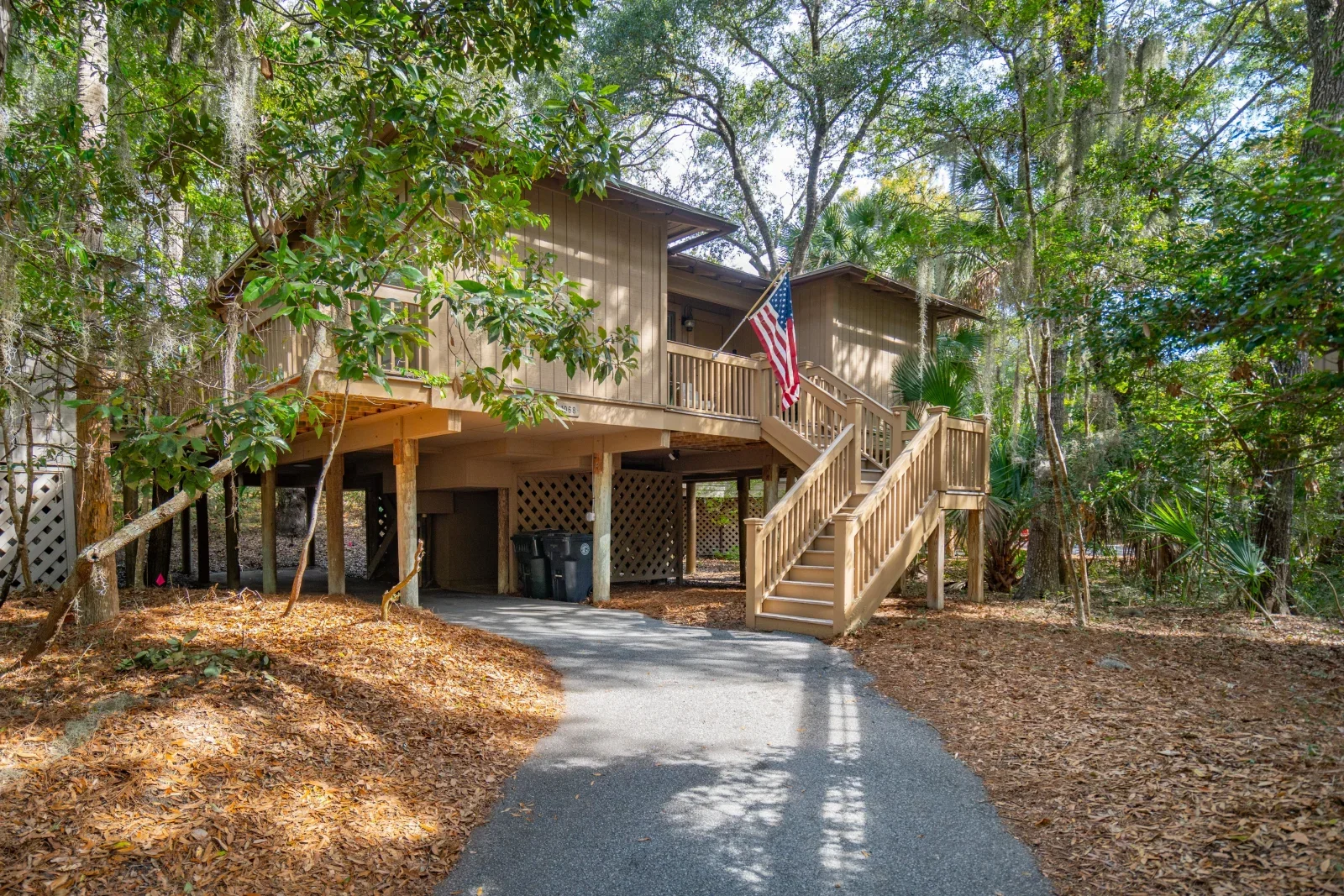 Elevated coastal beach house with wooden deck and oak trees on Kiawah Island