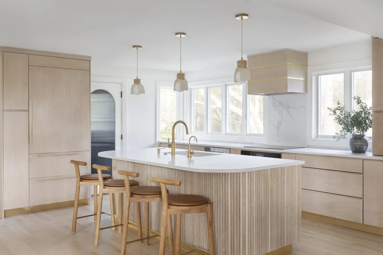 Modern luxury kitchen with white quartz island countertop and waterfront views at Kiawah Island SC property