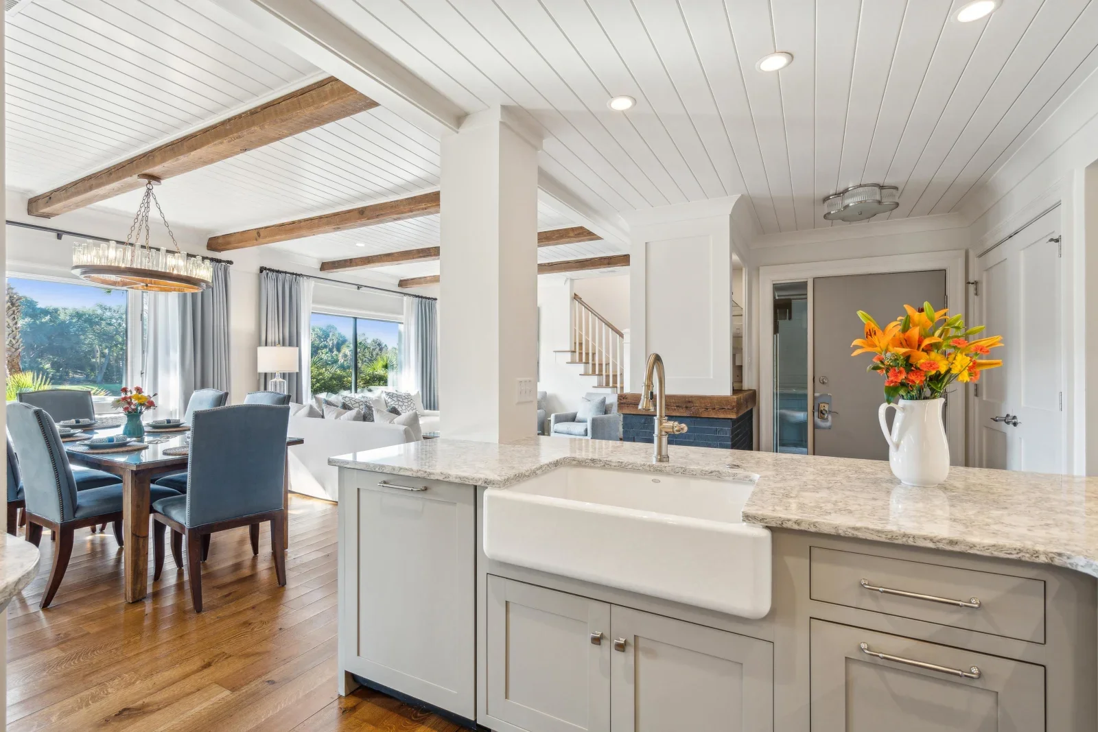 Modern open-concept kitchen with granite countertops and exposed beams at luxury Kiawah Island beach house