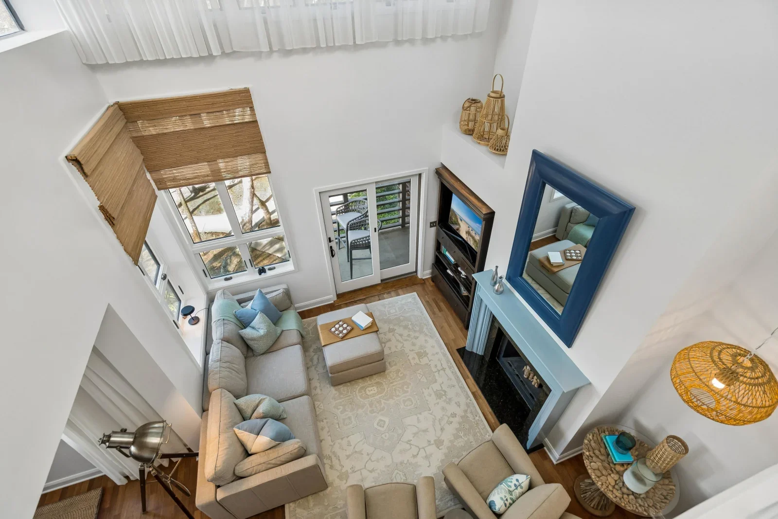 Bright coastal living room with beige sectional and fireplace in a Kiawah Island house rental