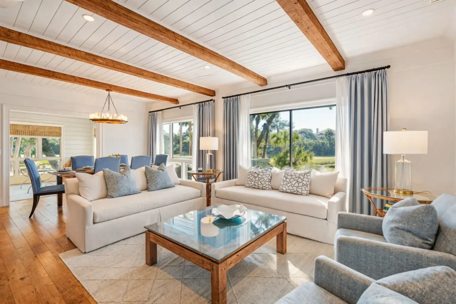 Elegant Kiawah Island Getaways vacation rental living room with exposed beams and lagoon views near golf courses