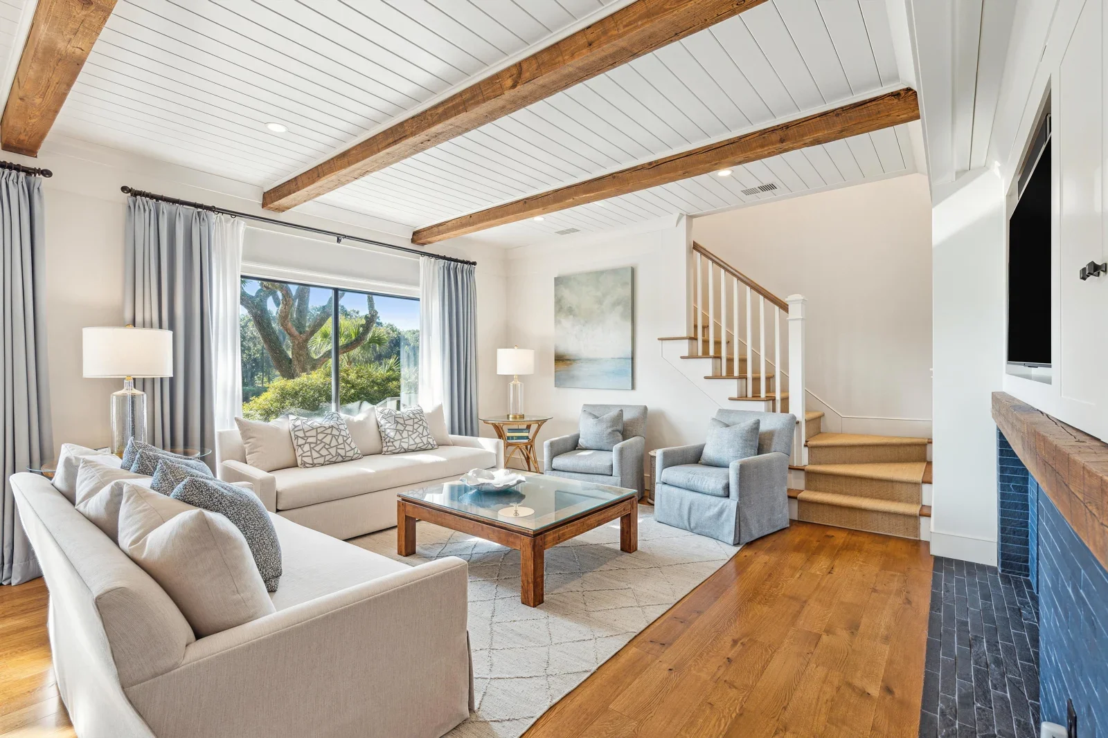 Open-concept living room with exposed beams and coastal design in Kiawah Island SC vacation rental homes