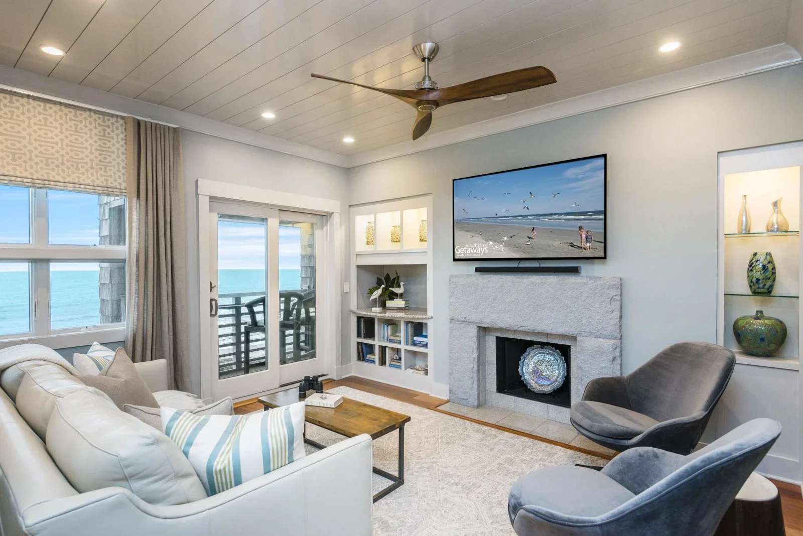 Modern living room with ocean views and fireplace at private beach boardwalk access property in Kiawah Island