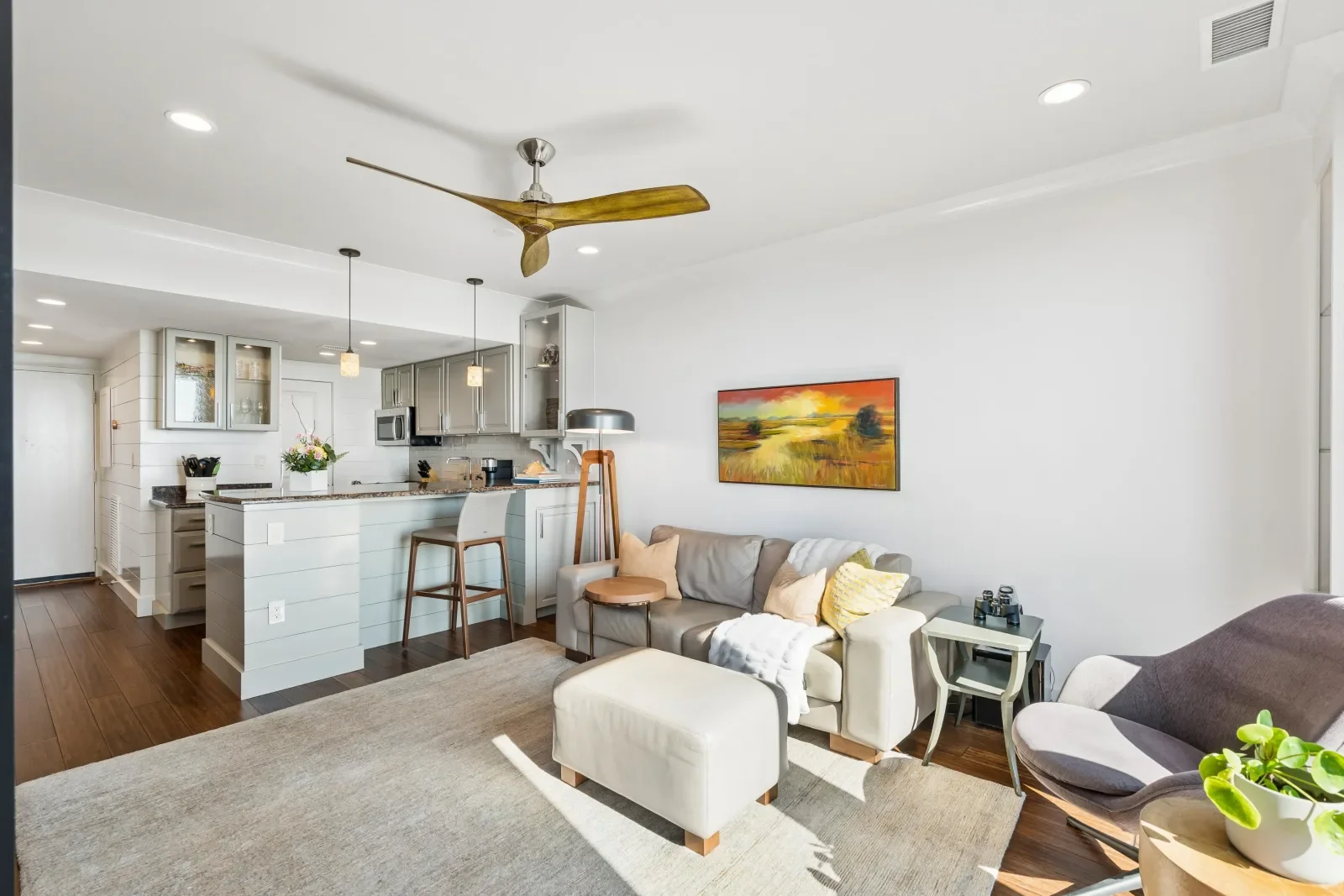 Modern open-concept kitchen and living room with island seating at The Vista at Shipwatch, Kiawah Island