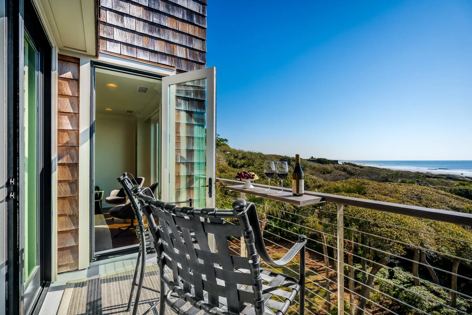 Private oceanfront deck at vacation rental home Kiawah Island SC with lounge chairs and panoramic beach views