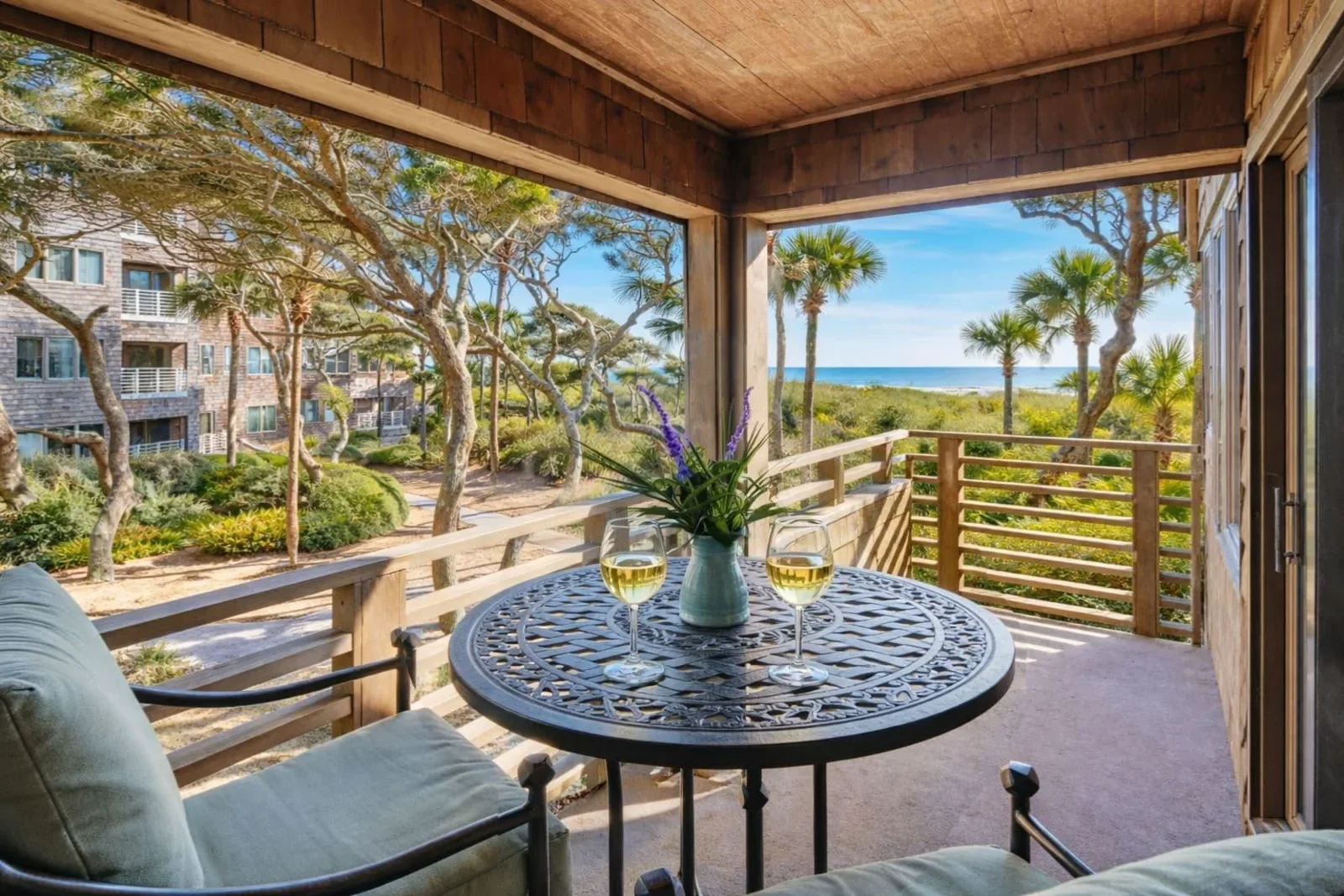 Kiawah Island house rentals screened porch with ocean views, round table, and coastal seating