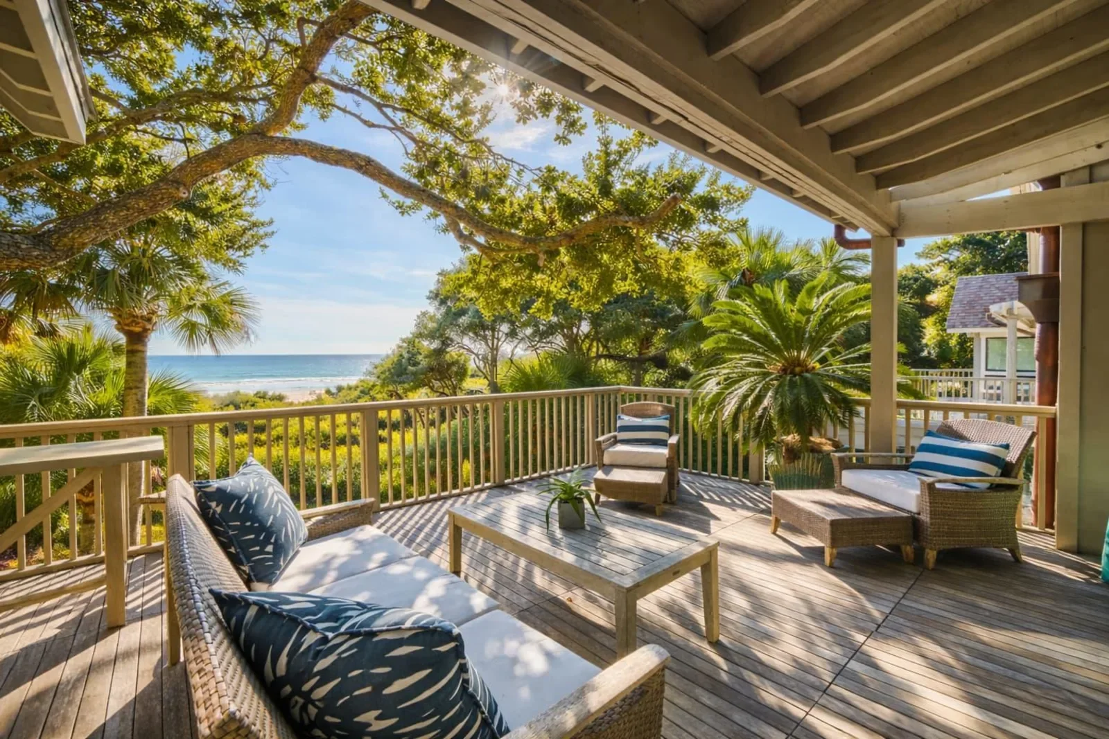 Coastal deck with ocean and beach views, lounge seating, and tropical landscaping at Kiawah Island SC