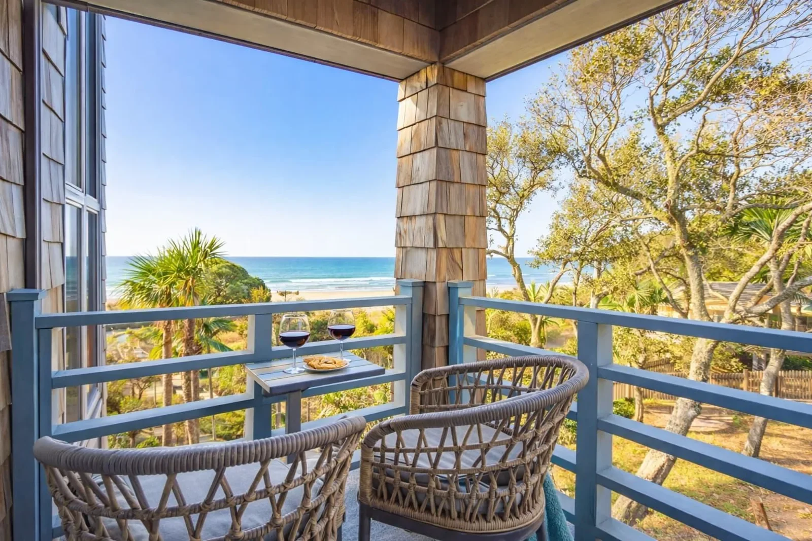 Oceanfront patio with woven chairs and beach views at Kiawah Island SC vacation rental