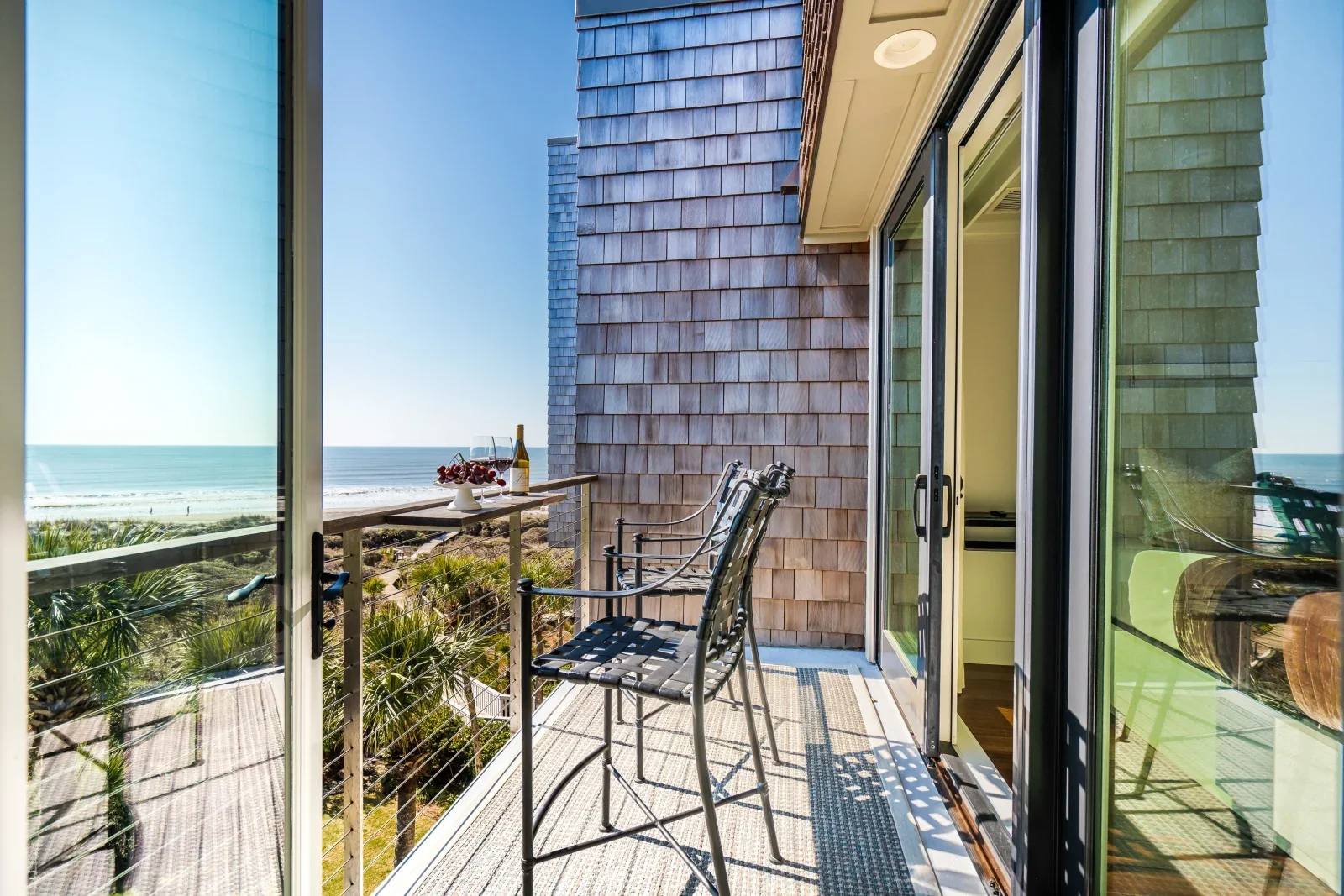 Oceanfront balcony with wine and modern seating overlooking the Atlantic at Kiawah Island