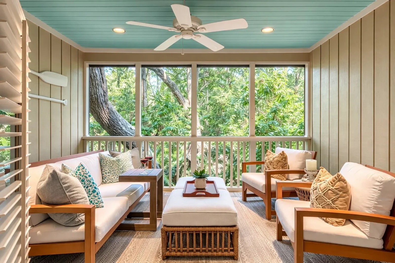 Screened oceanfront patio with turquoise ceiling and coastal furniture at Kiawah Island house rental