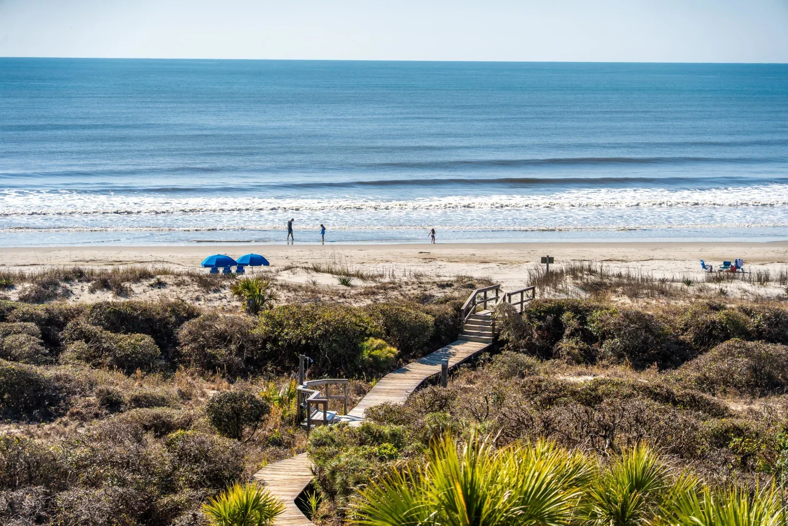 Wooden boardwalk through coastal dunes leading to sandy beach at Kiawah Island vacation rental