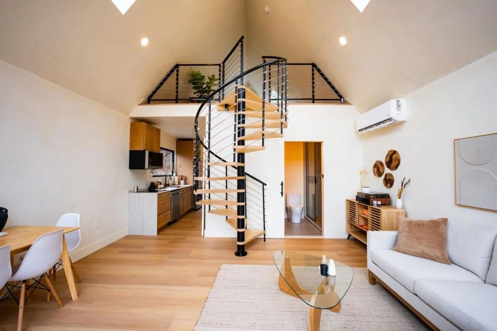 Modern loft living room with spiral staircase at Royal Oak Retreat near Shenandoah Valley