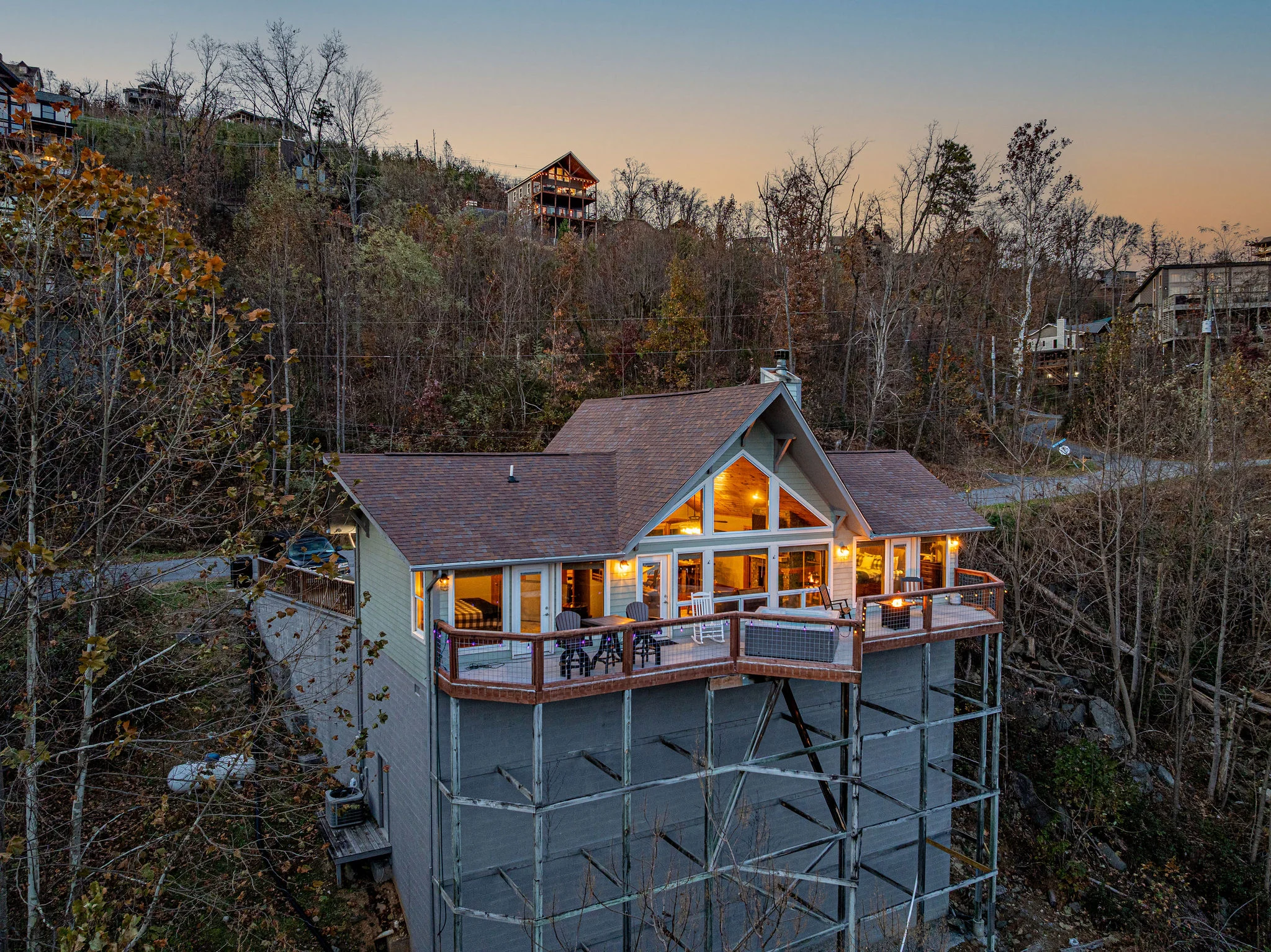 Modern elevated lodge exterior with forest views at dusk near Gatlinburg TN