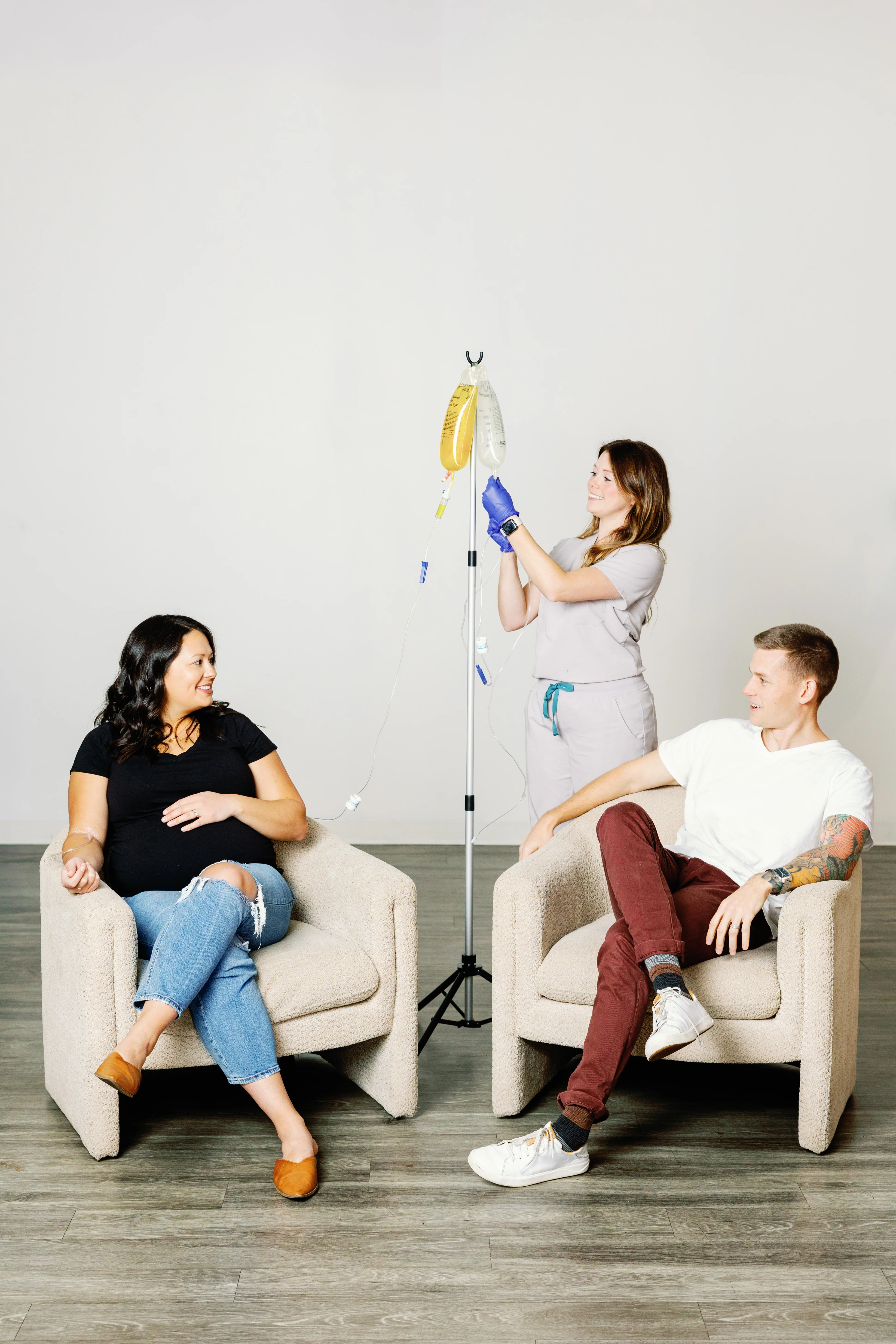 Three people in minimalist room with cleaning supplies on pole, Living Salt promotional staging